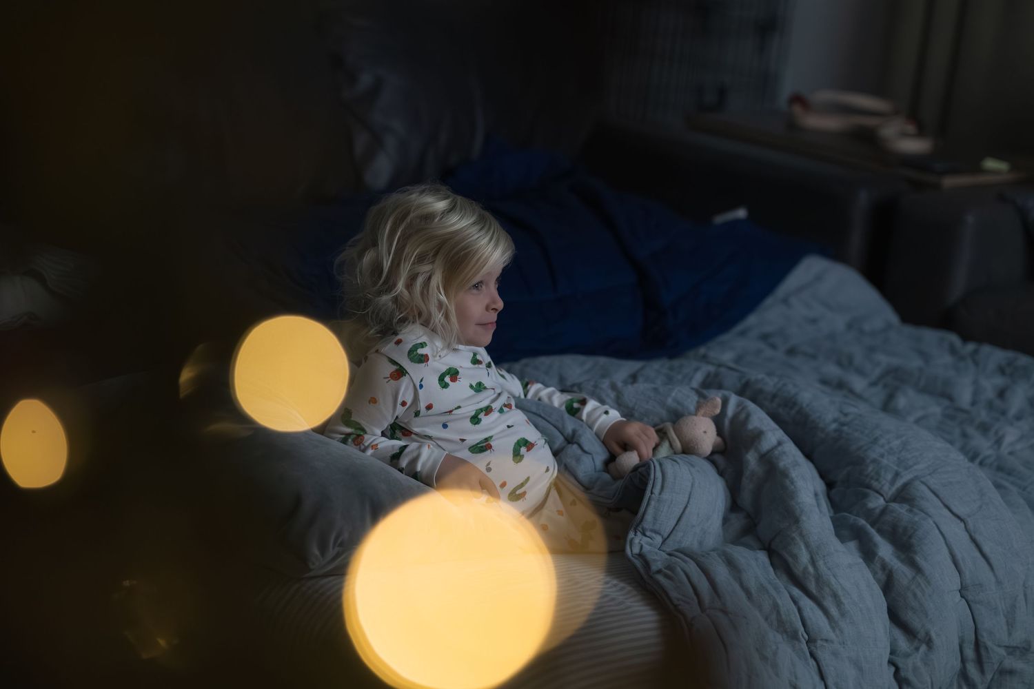 Blurred bokeh lights create a dreamy golden glow effect against a dark background.