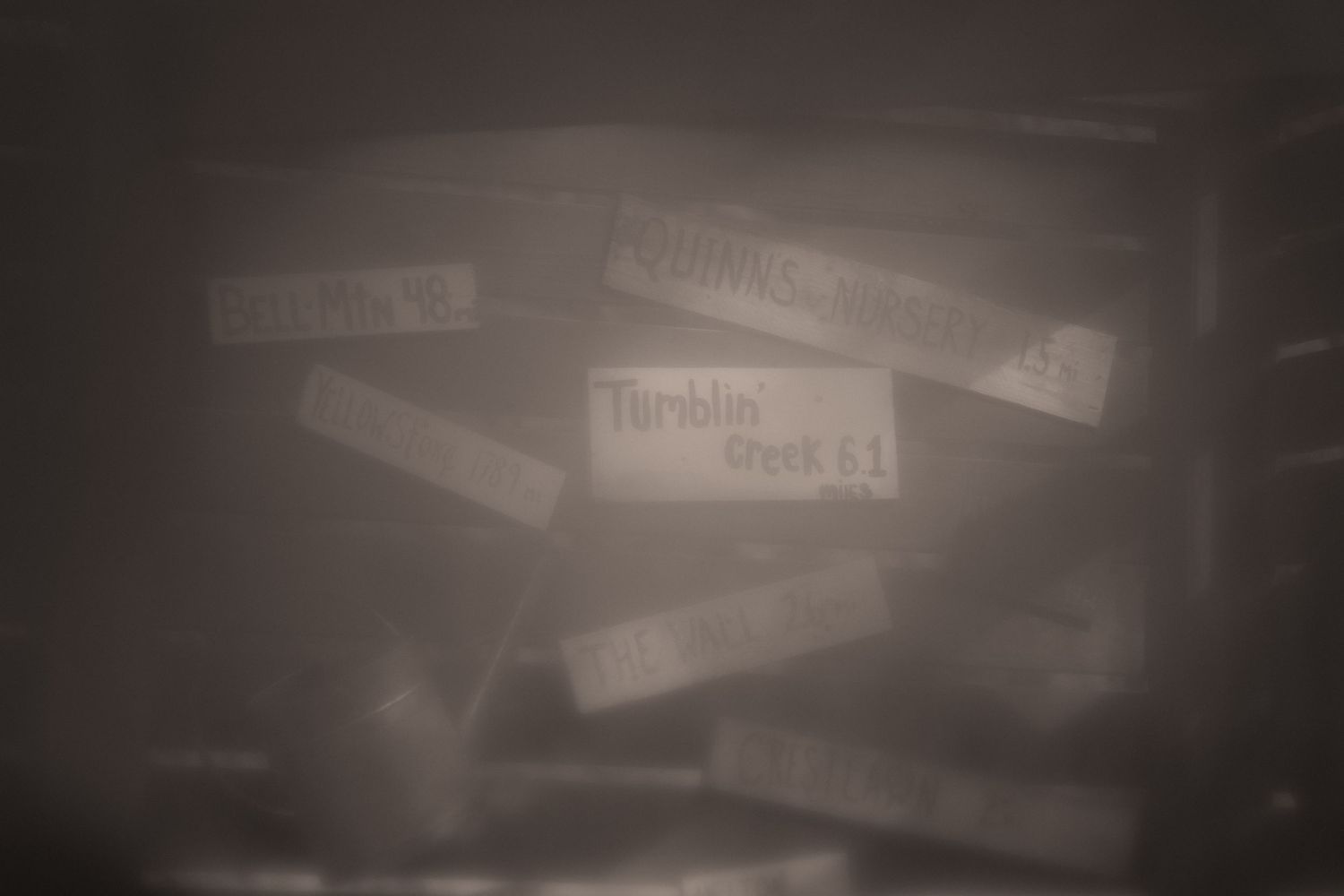 Scattered paper labels in a dark, moody setting with one readable tag labeled Turnitin Deck 11.