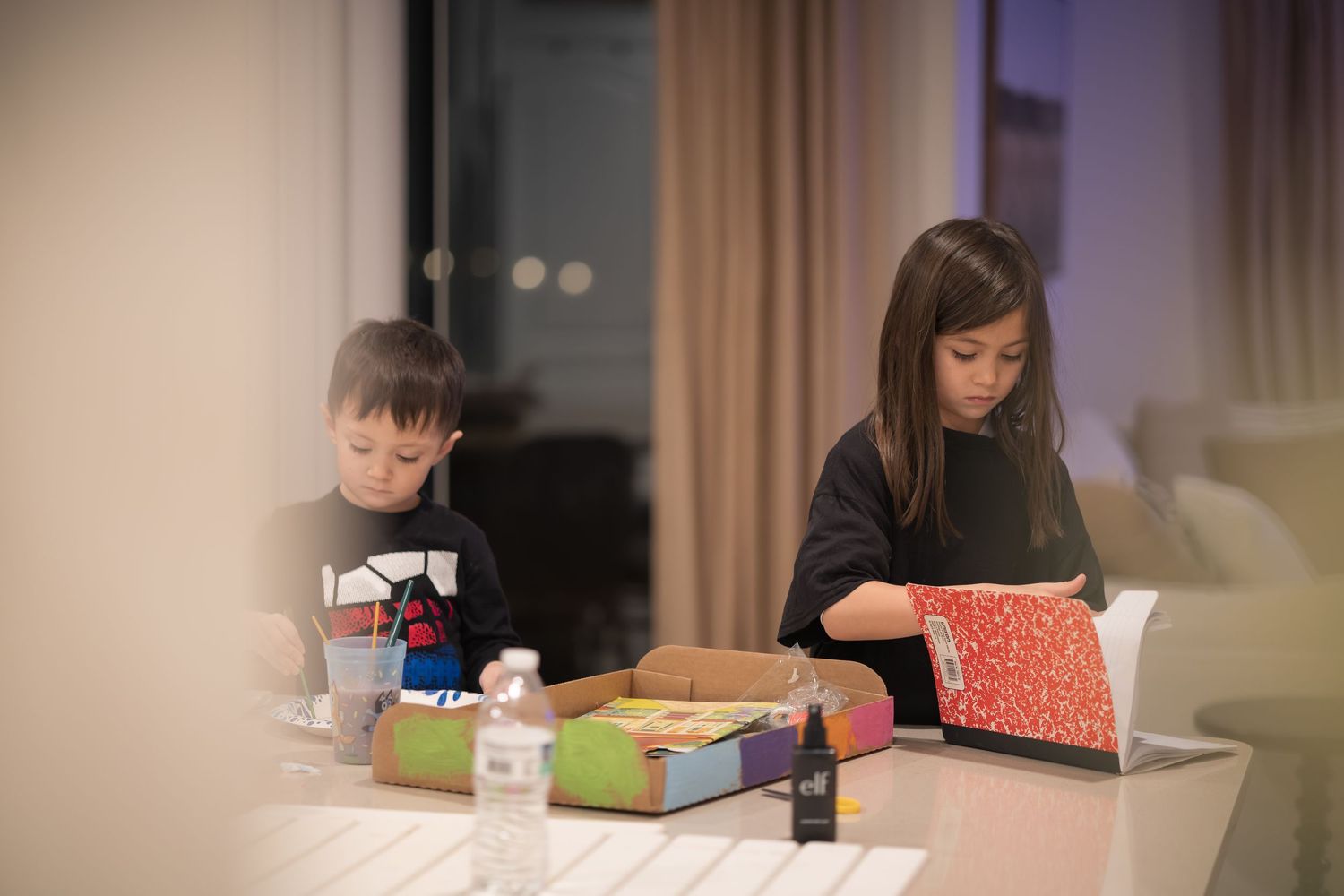 People working on creative projects together at a shared table.