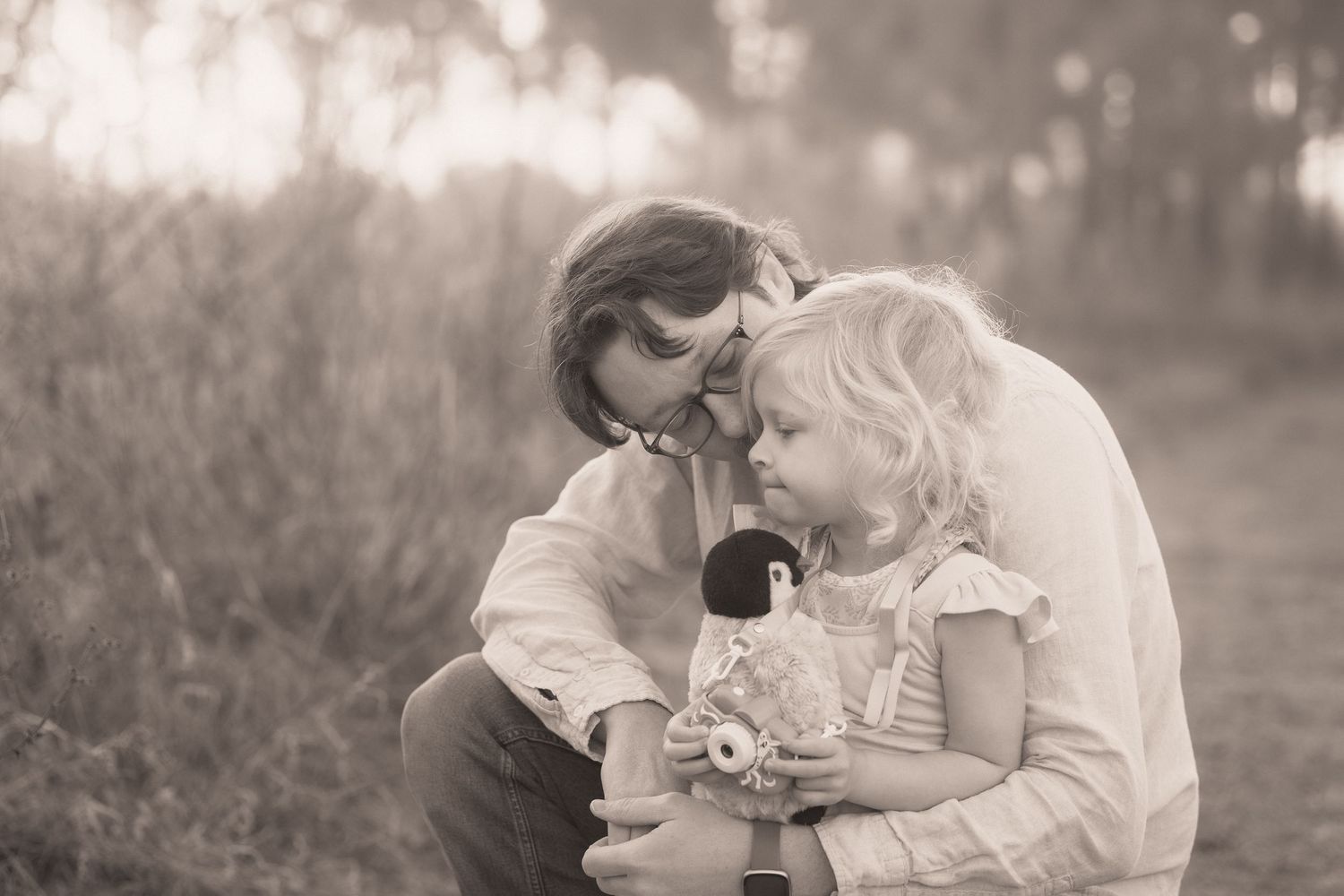A series of romantic black and white photographs showing tender moments between a couple in an outdoor setting.