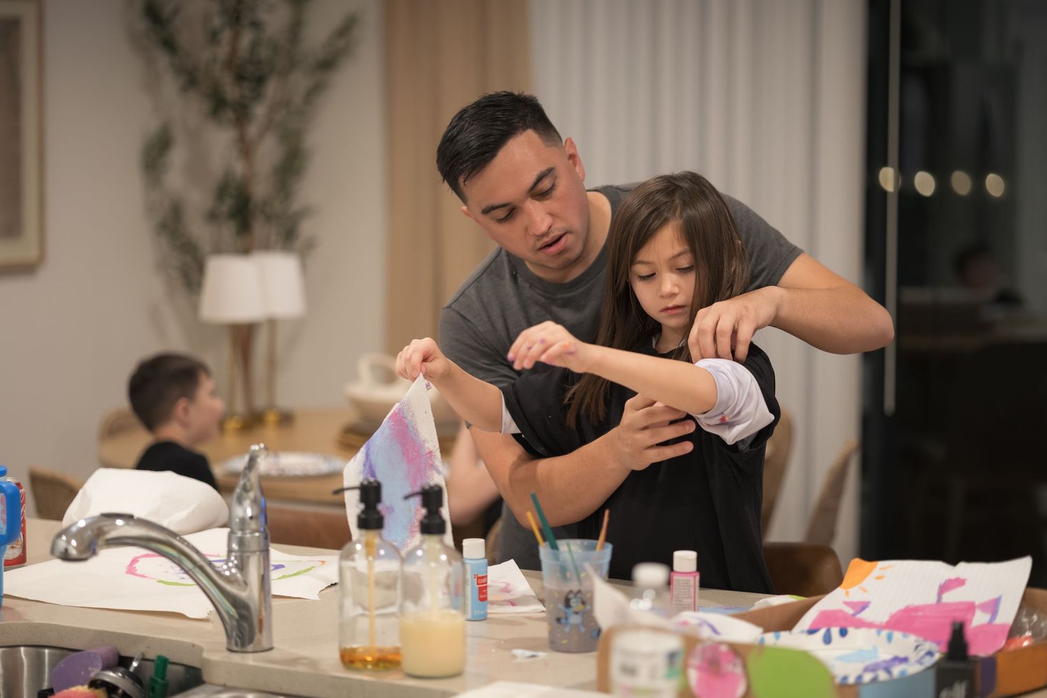 Family spending quality time together doing crafts at home.