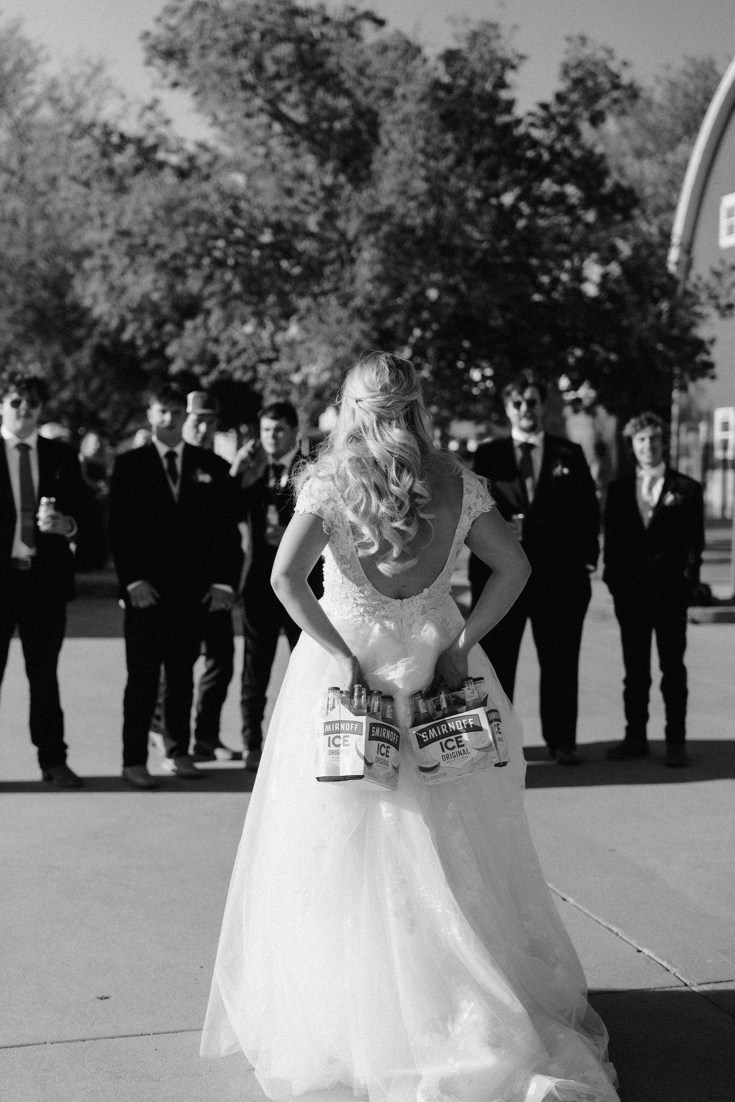 bride icing the groomsmen at wedding reception