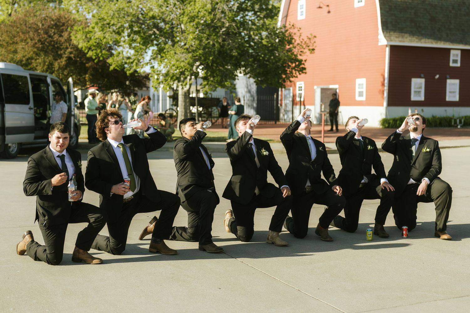 bride icing the groomsmen at wedding reception