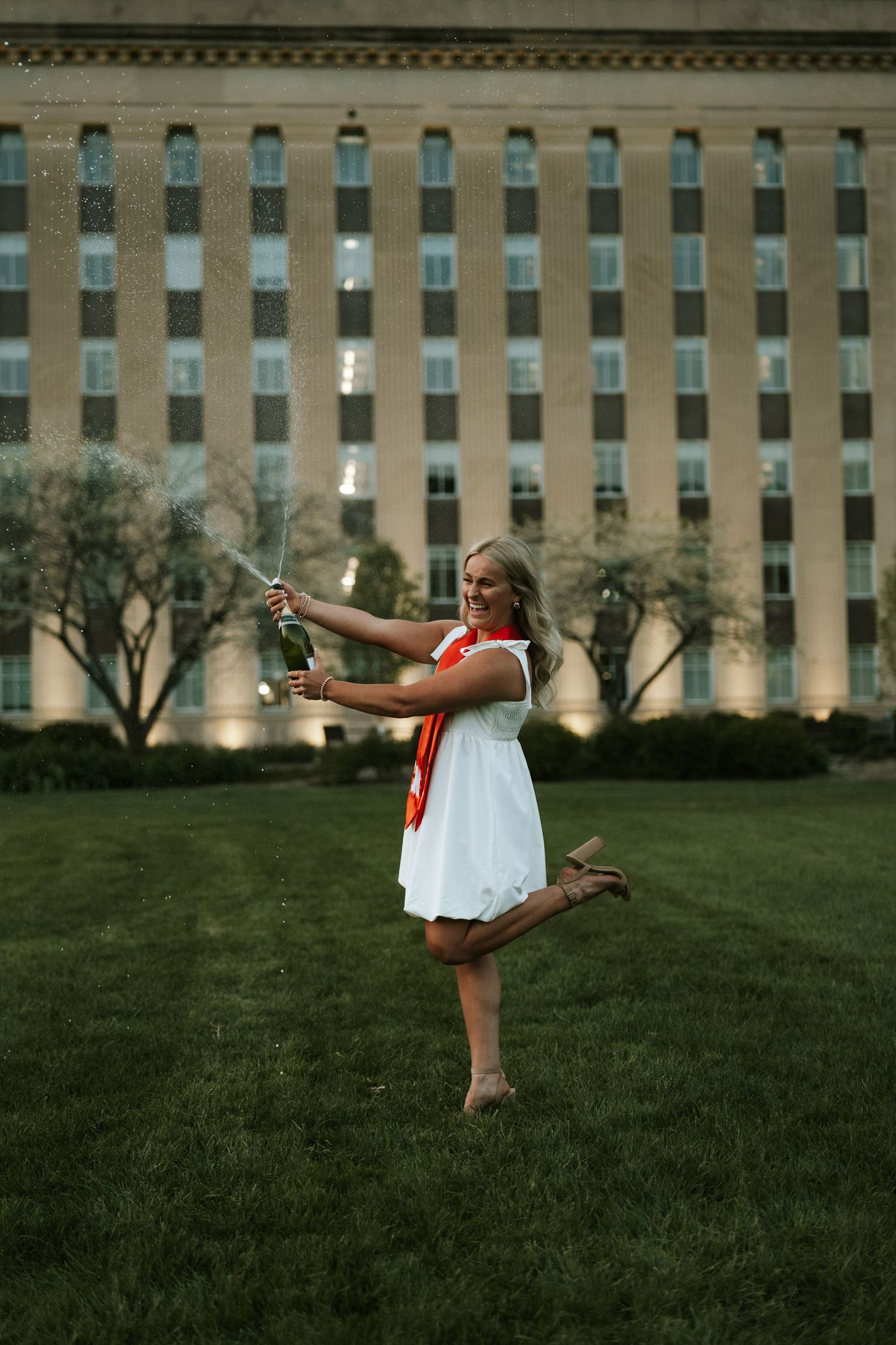 girl popping champagne grad photos