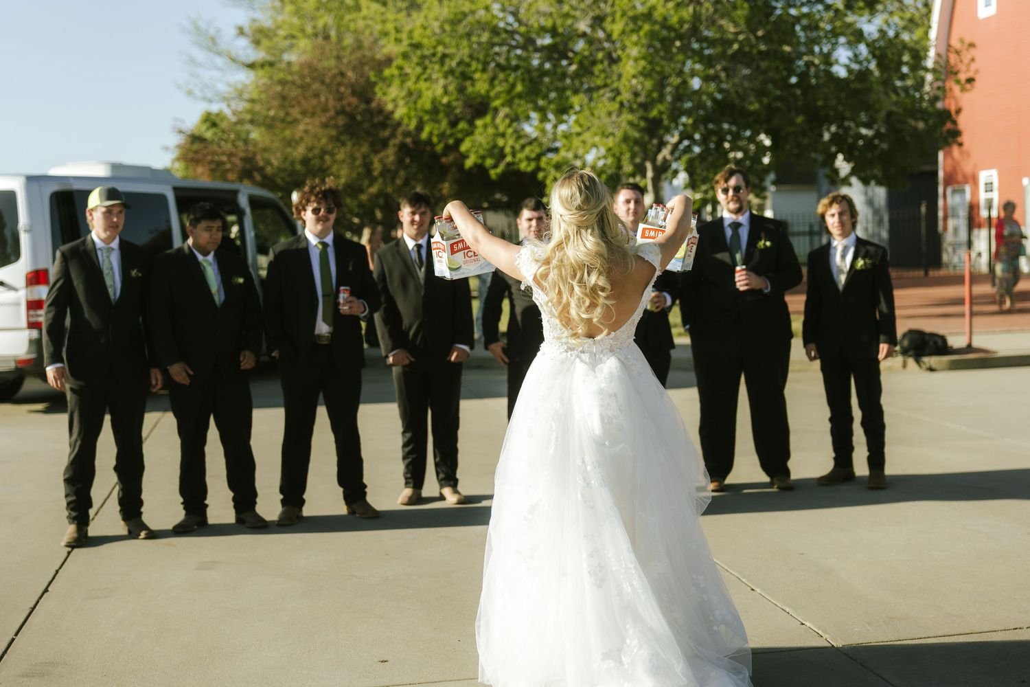 bride icing the groomsmen at wedding reception