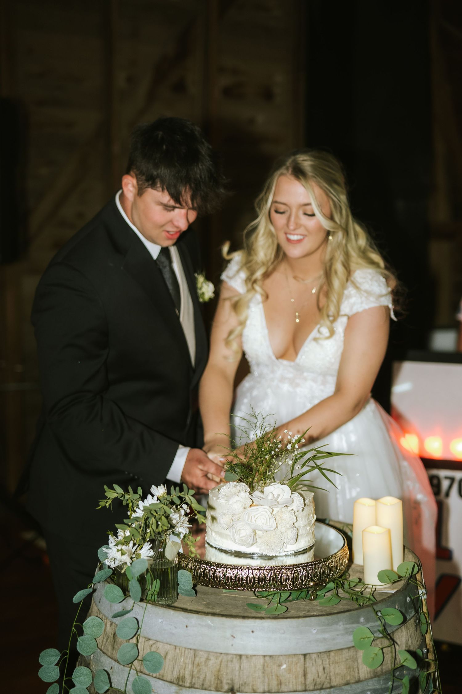 couple cutting cake at wedding reception
