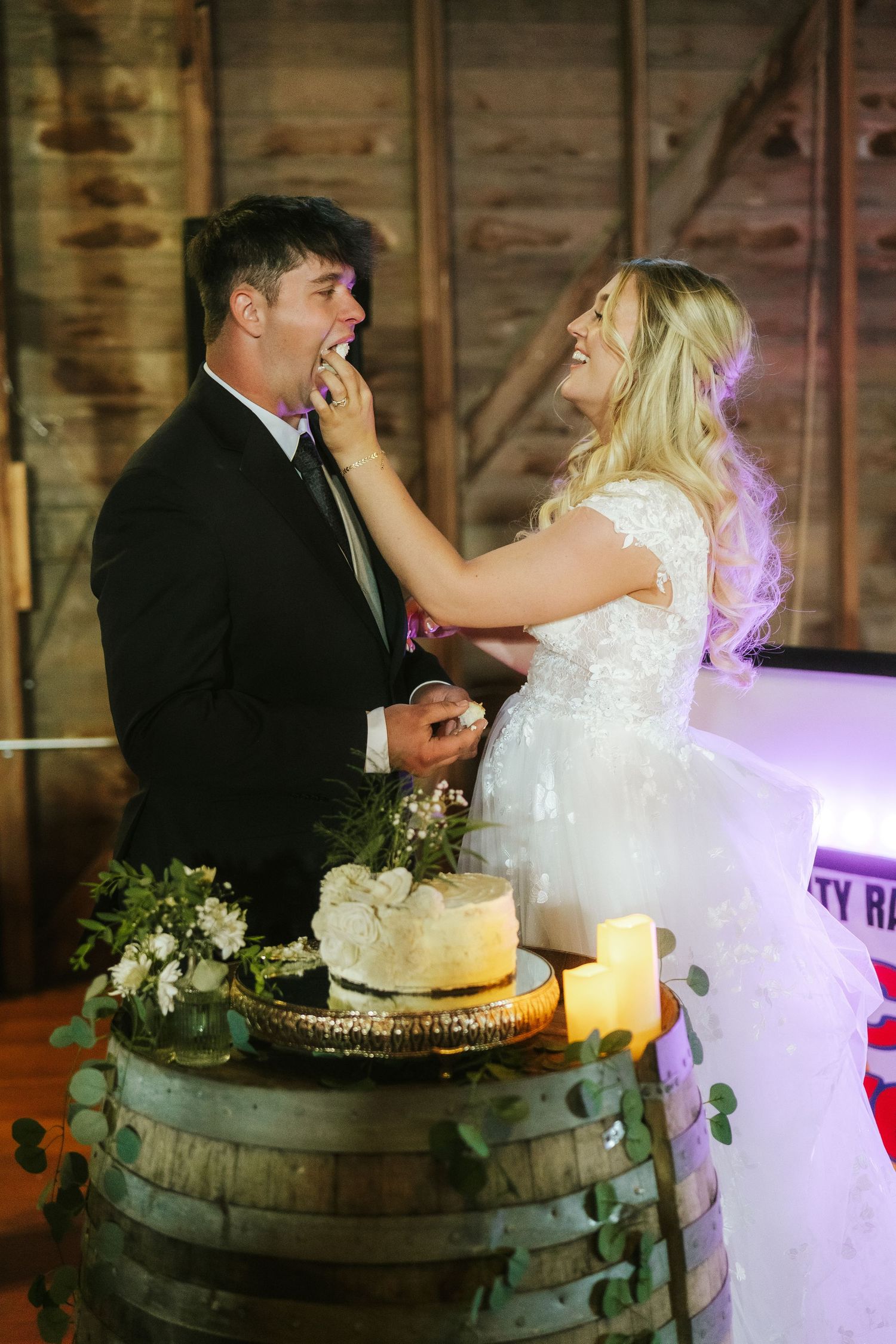 couple cutting cake at wedding reception