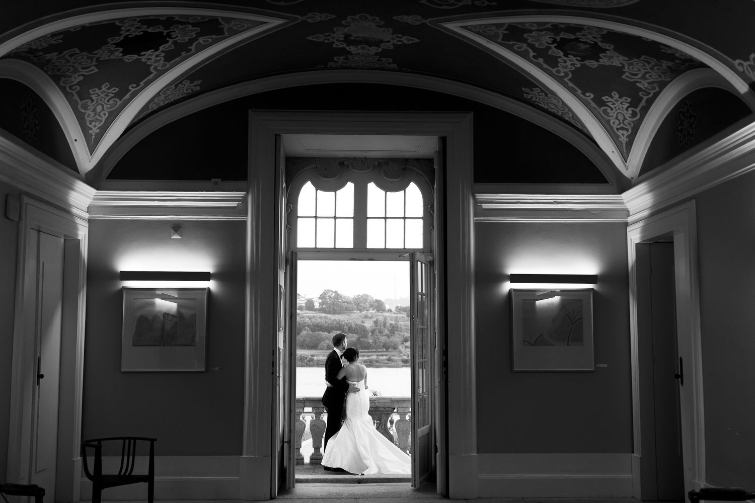 Wedding venue interior with dramatic arched windows and architectural details.
