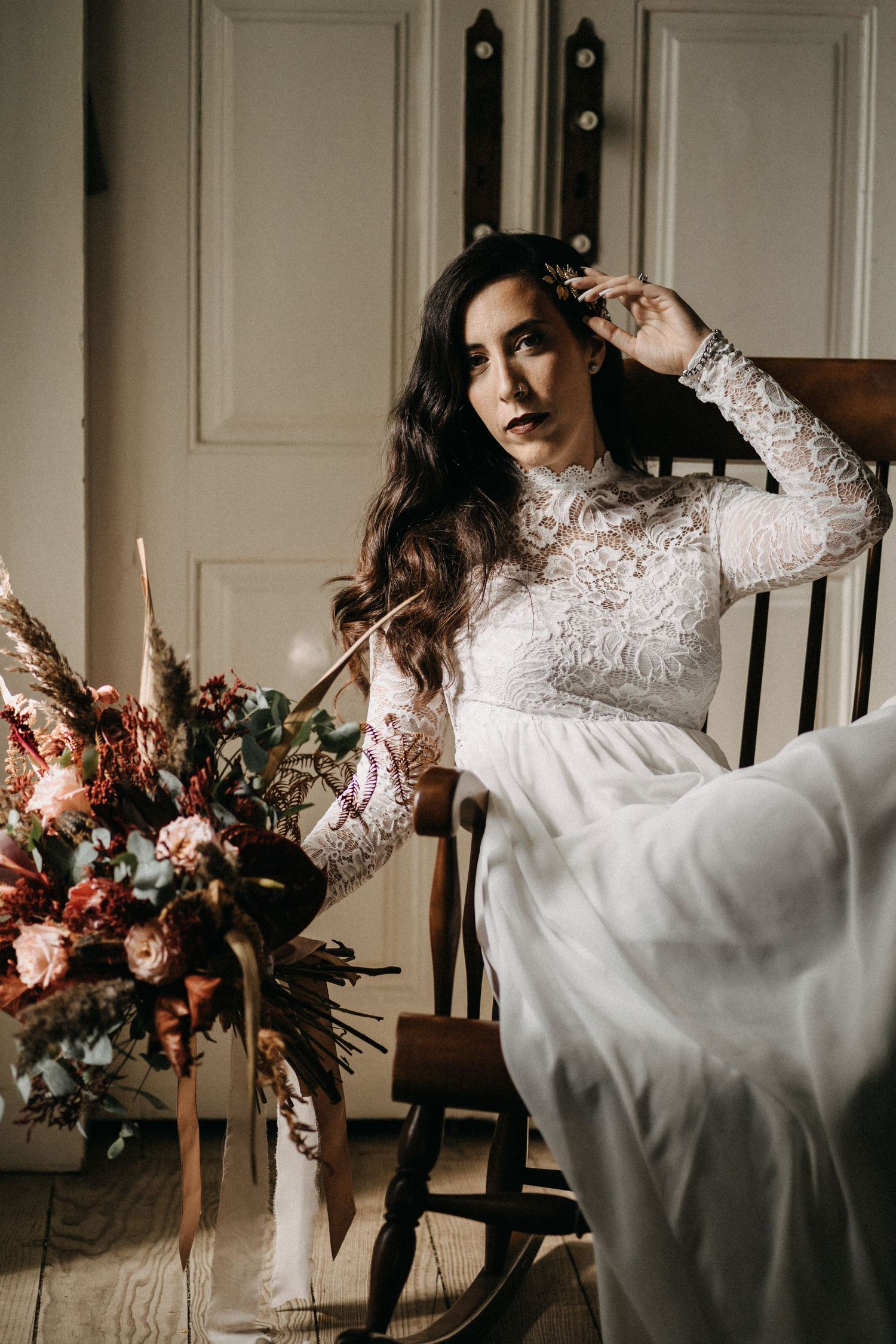 A bridal portrait session featuring an elegant lace dress and floral bouquet.