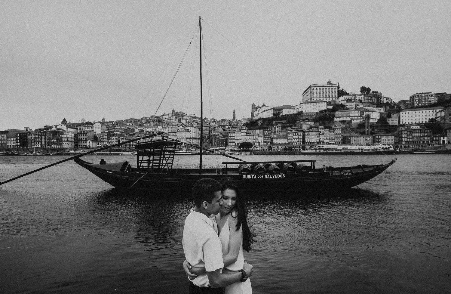Vintage black and white photographs showing boats and waterfront scenes along a historic harbor.