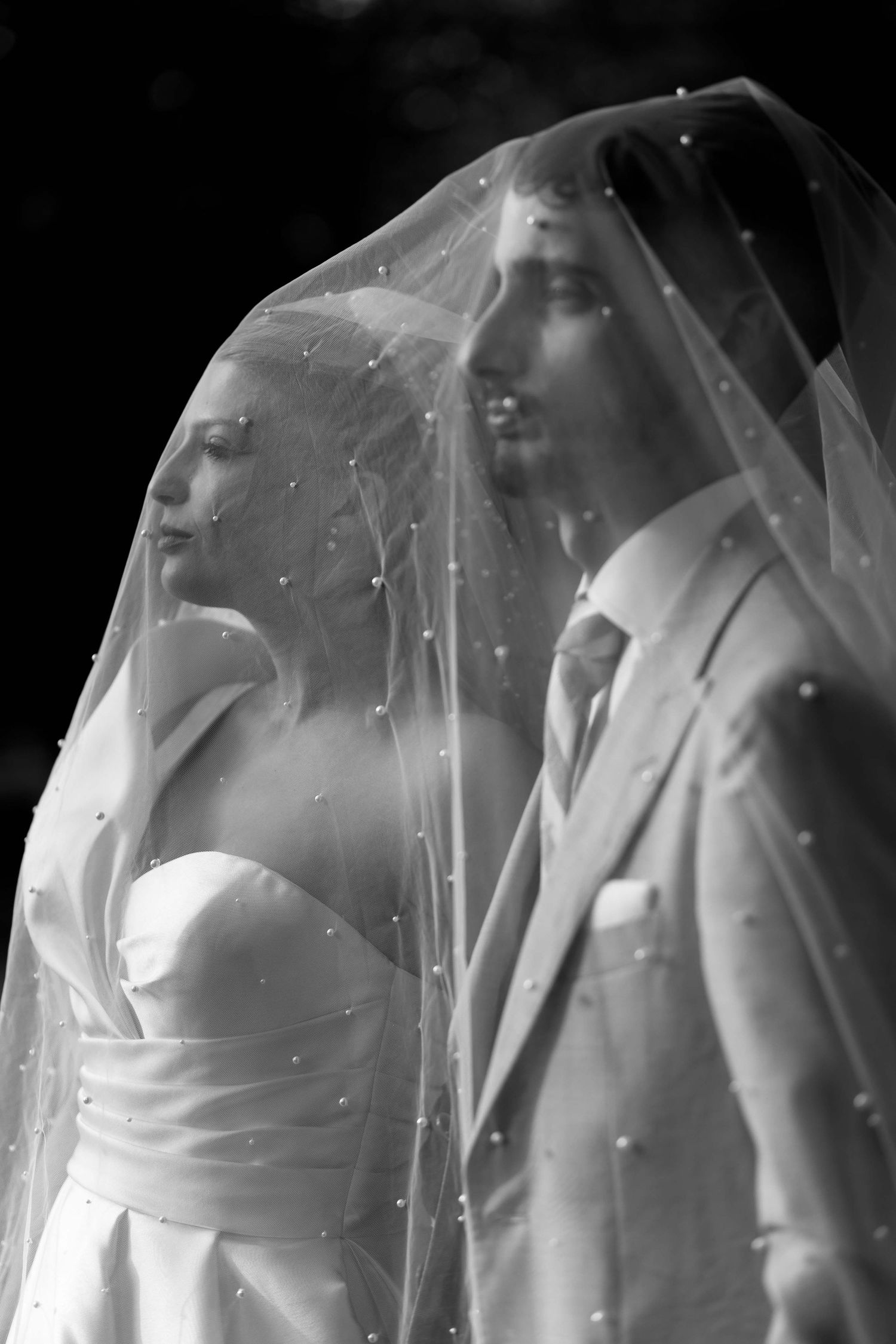 A sequence of black and white photographs showing a figure in white clothing through a translucent veil or fabric.