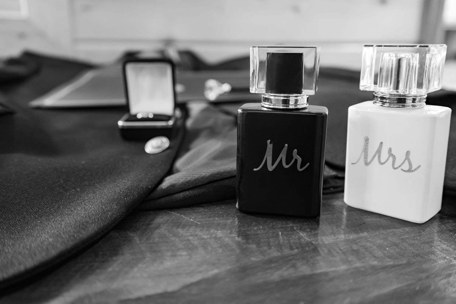 Black and white wedding details including Mr and Mrs signs, rings, and elegant decor elements arranged on a table.