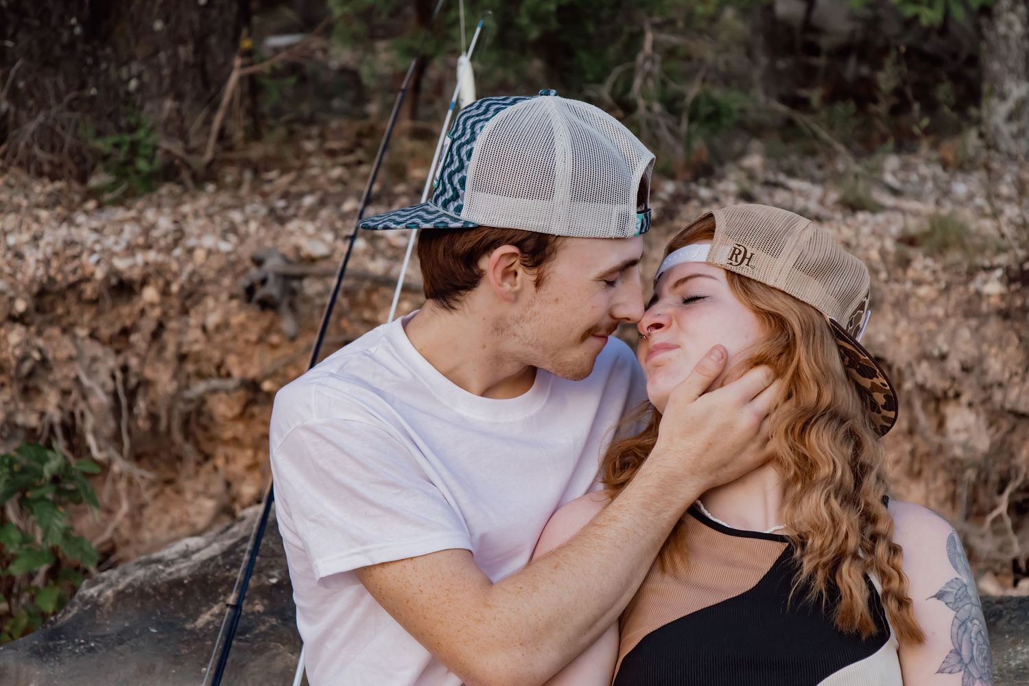 A couple shares tender moments while hiking outdoors in nature, shown in a series of romantic photographs.