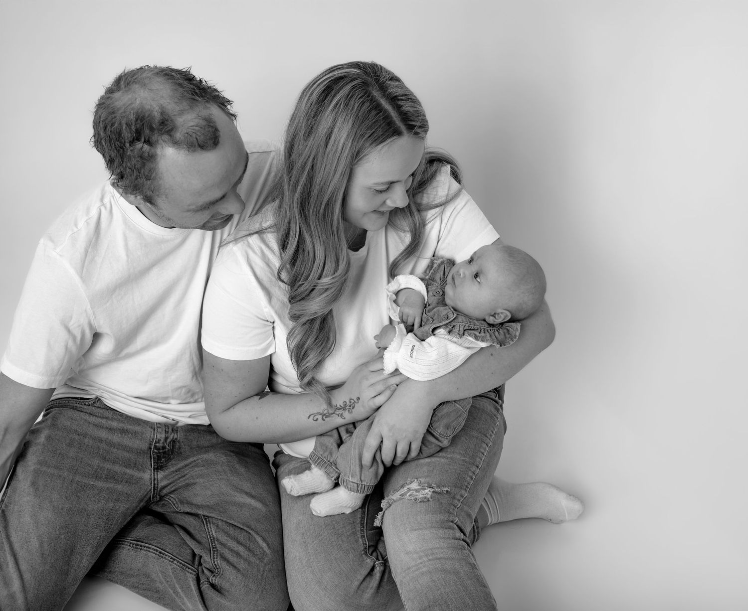 A series of four black and white photographs showing intimate moments of affection between people.
