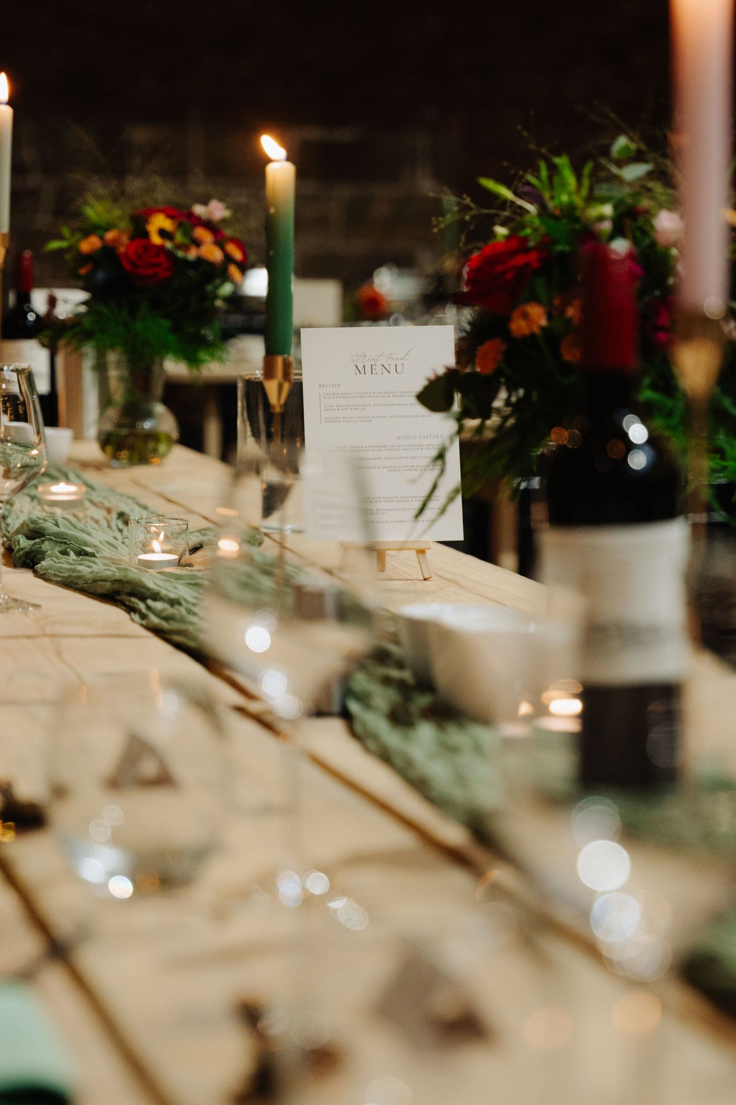 Elegant wedding reception table setting with white linens, candlelight and floral arrangements creating a romantic atmosphere. Glasgow Engin