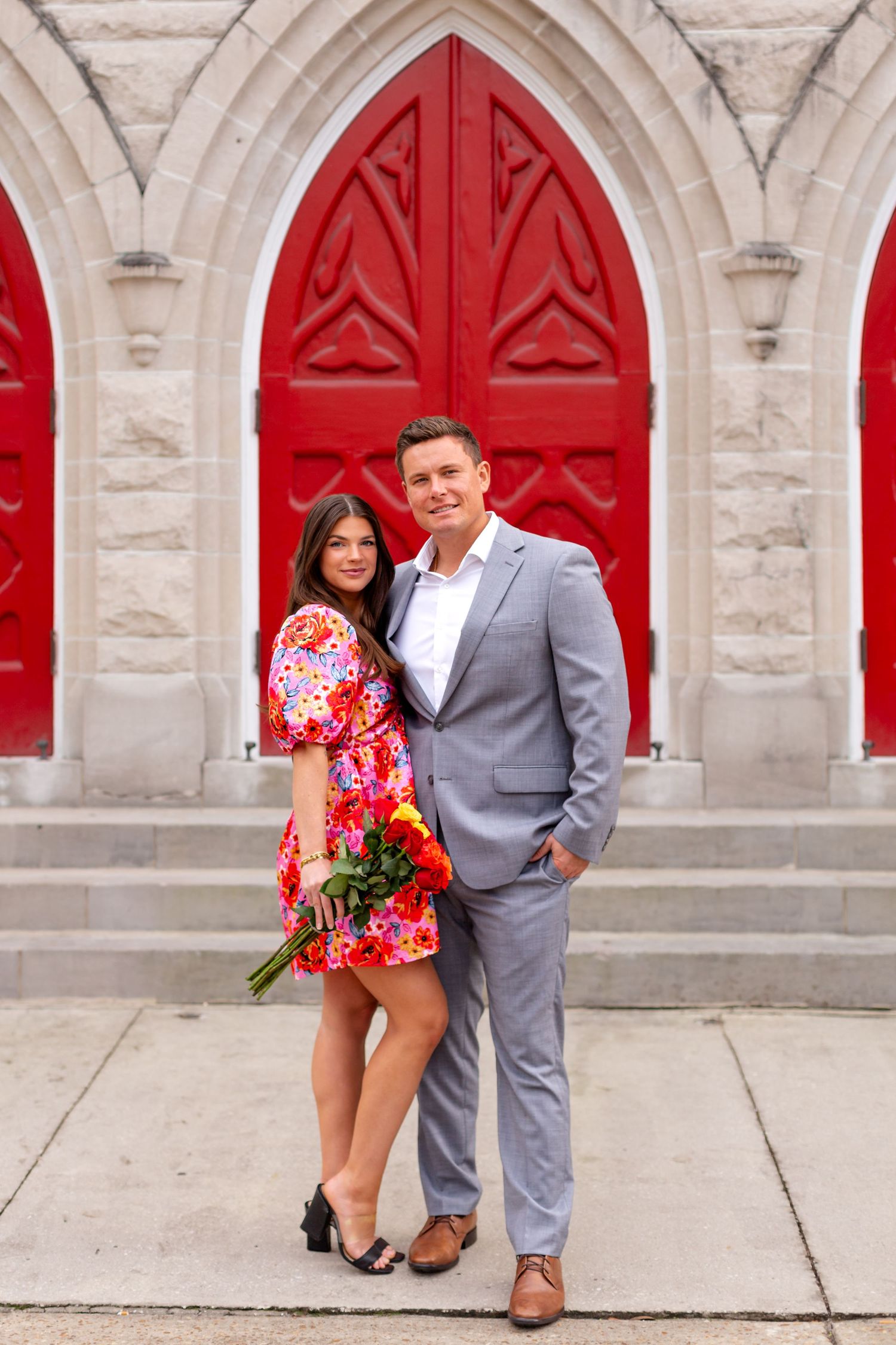 Man and woman couple posing in front of church doors in Downtown Jacksonville.