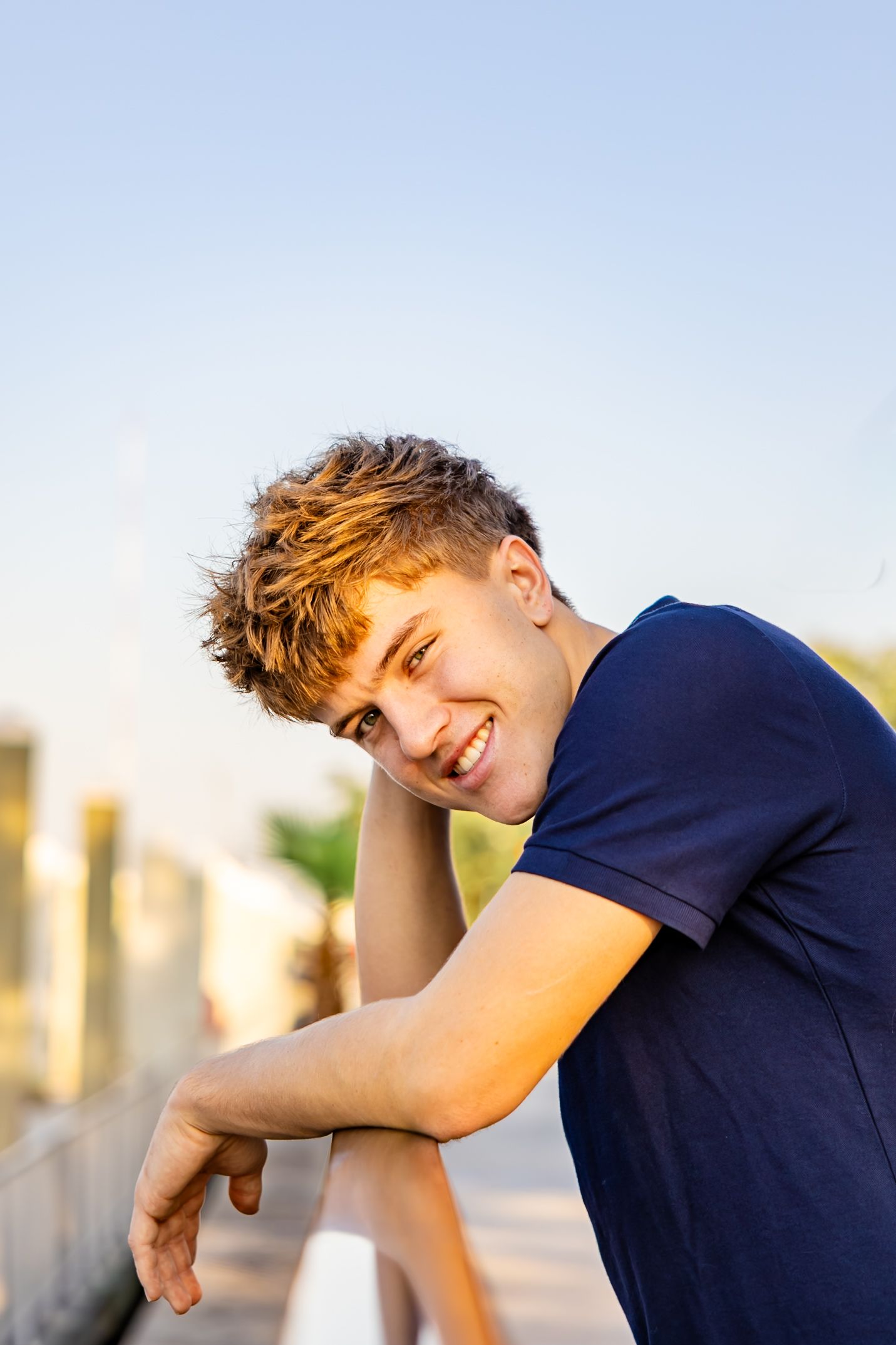 Senior guy portrait session at Friendship Fountain during golden hour lighting.