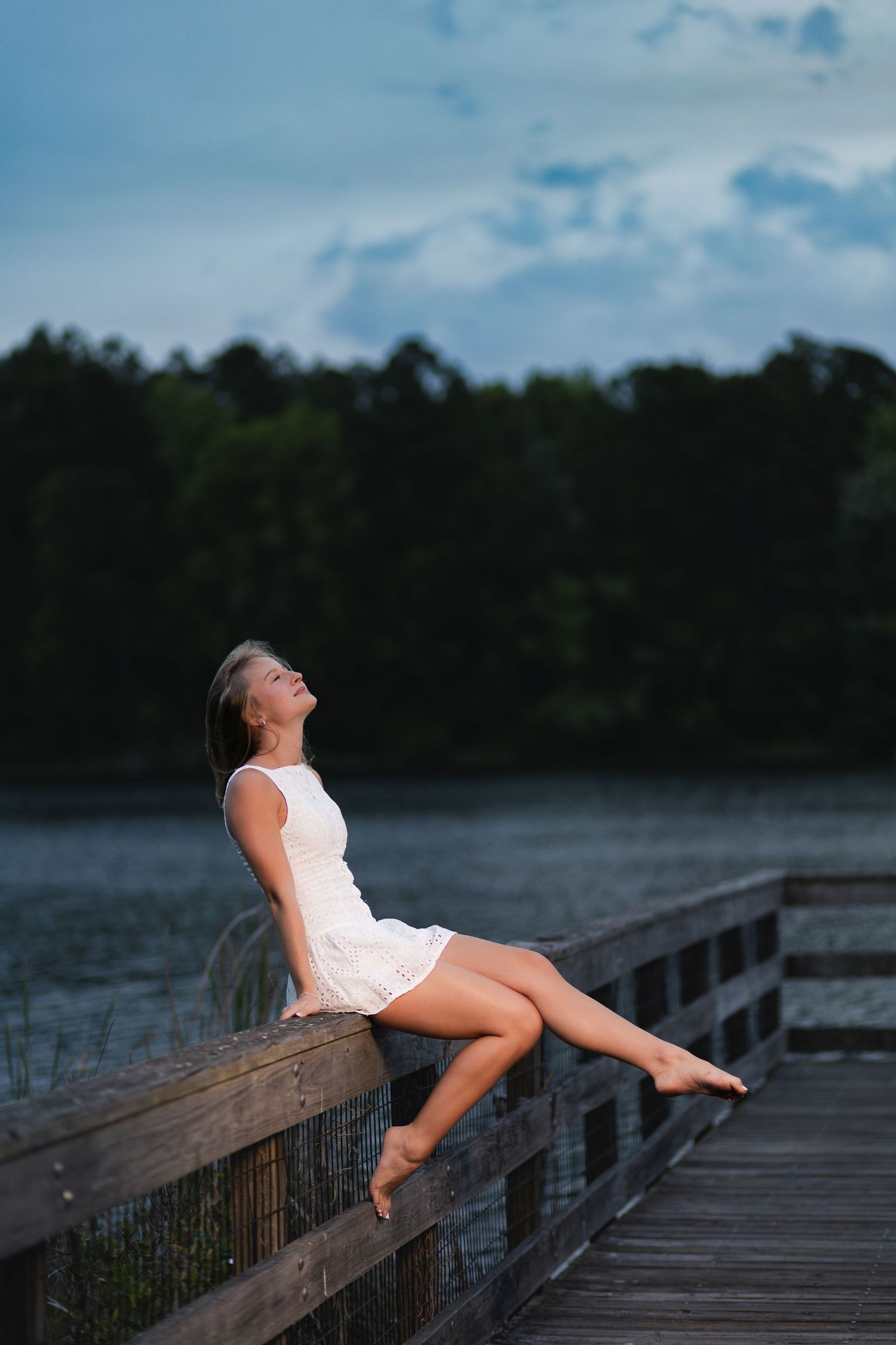 Nease High School senior standing on a waterfront dock at Sheffield Regional Park.