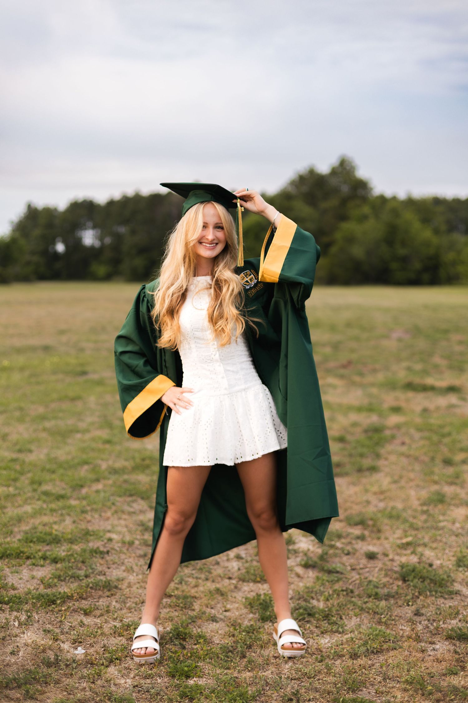 Nease High School Class of 2026 senior posing in her cap and gown at Sheffield Regional Park.