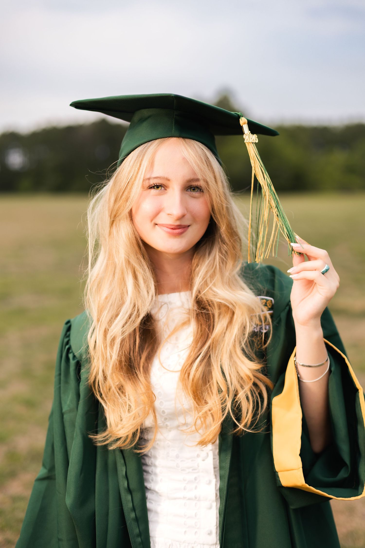 High school senior wearing her cap and gown during graduation portraits in Jacksonville.