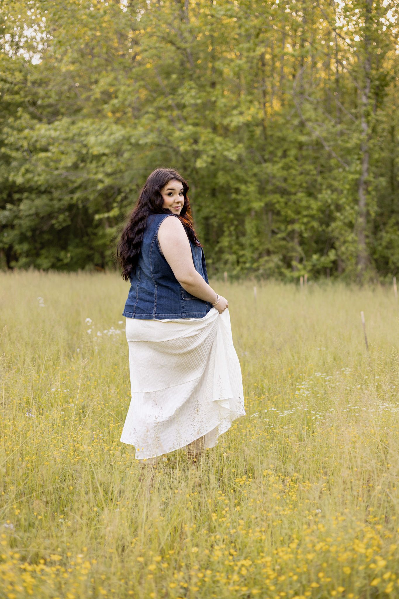 Woman in a flowing skirt walking through a wildflower field, Huntsville Alabama individual portrait session
