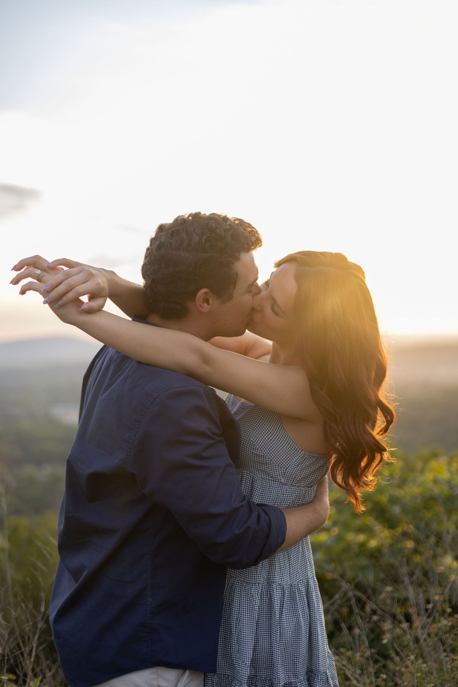 Couple embracing during their golden hour engagement session