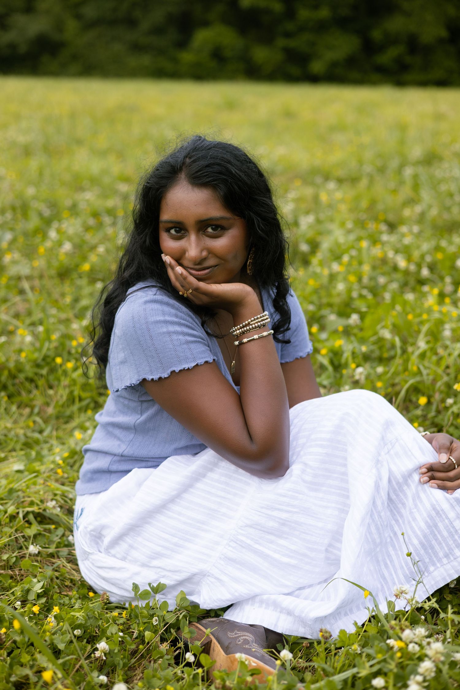 Woman in a white dress sitting in a grassy field, Huntsville Alabama individual portrait session