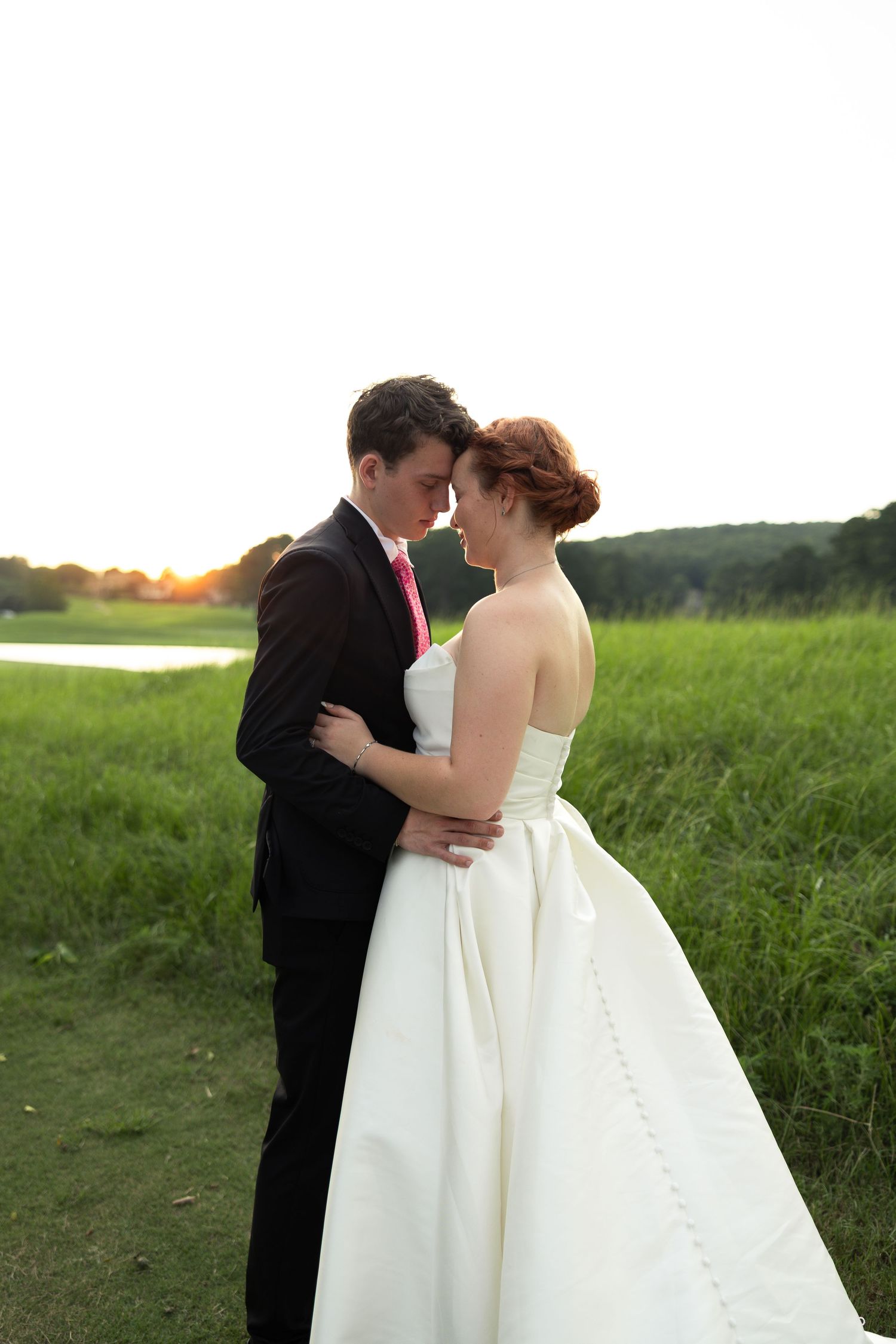 Newlywed couple enjoying golden hour wedding portraits