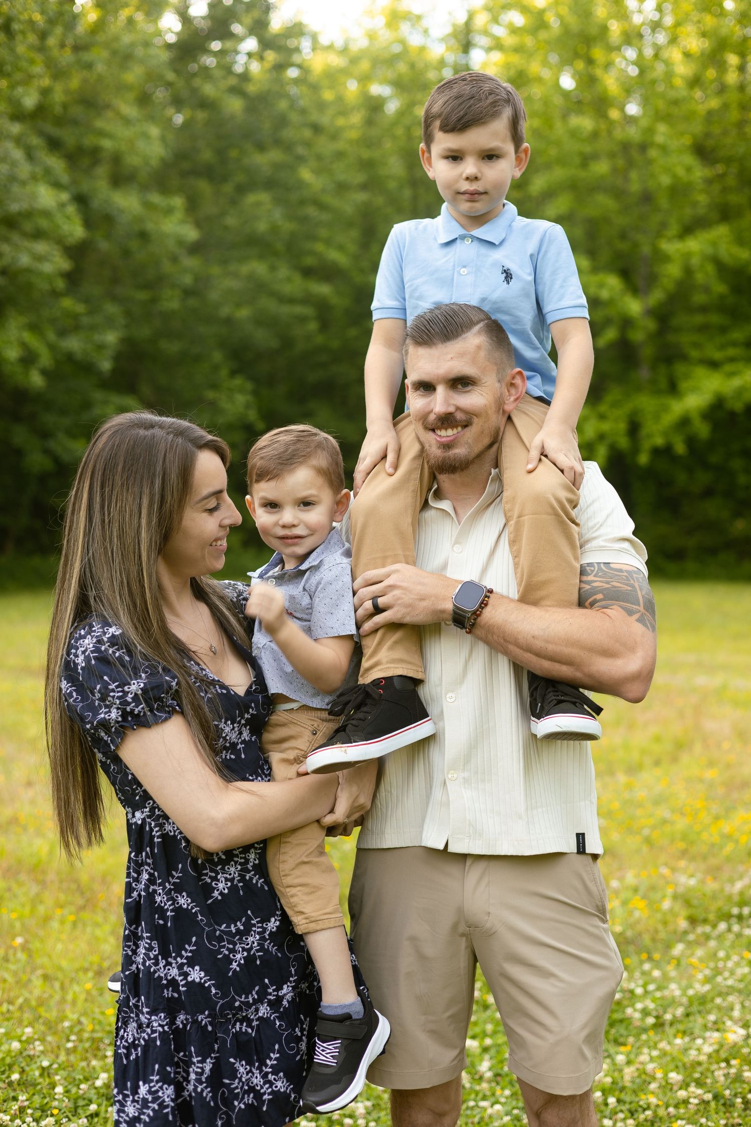 Family embracing outdoors in a wooded area, Huntsville Alabama family session