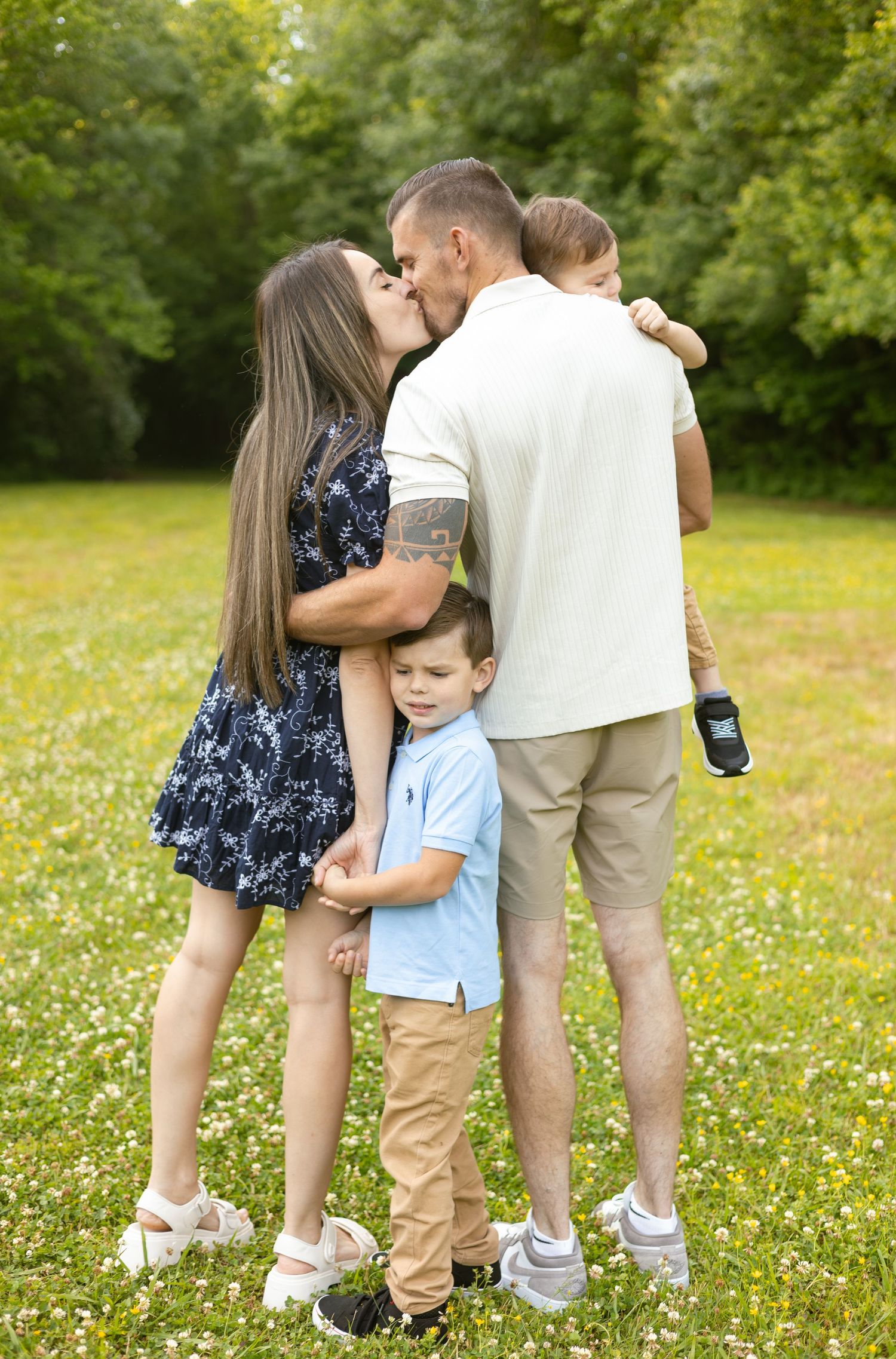 Family of four hugging together outdoors, Huntsville Alabama family photographer