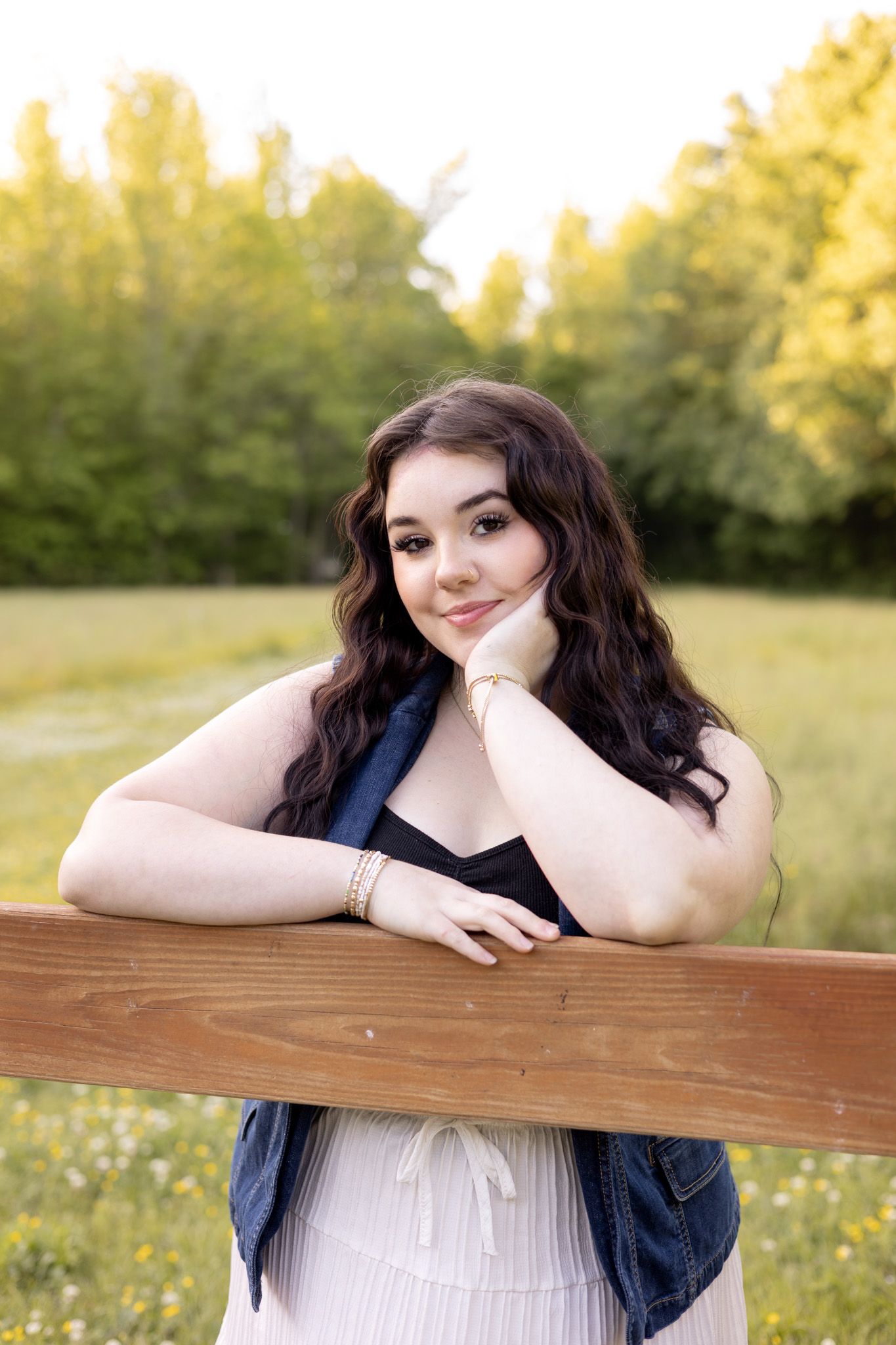 Woman leaning on a wooden fence in a golden field, Huntsville Alabama individual portrait session