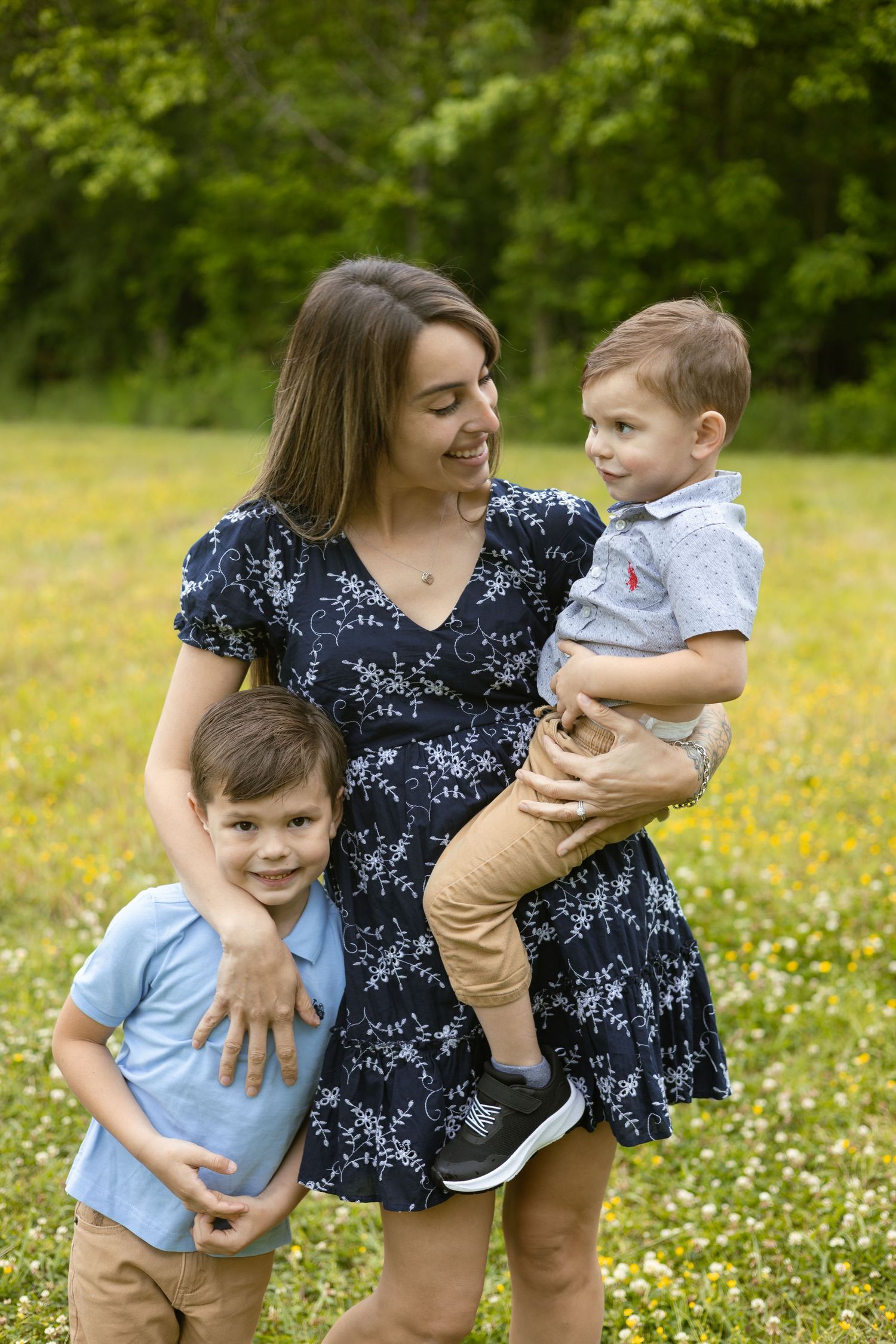 Mother holding her sons in a grassy field, Huntsville Alabama family session