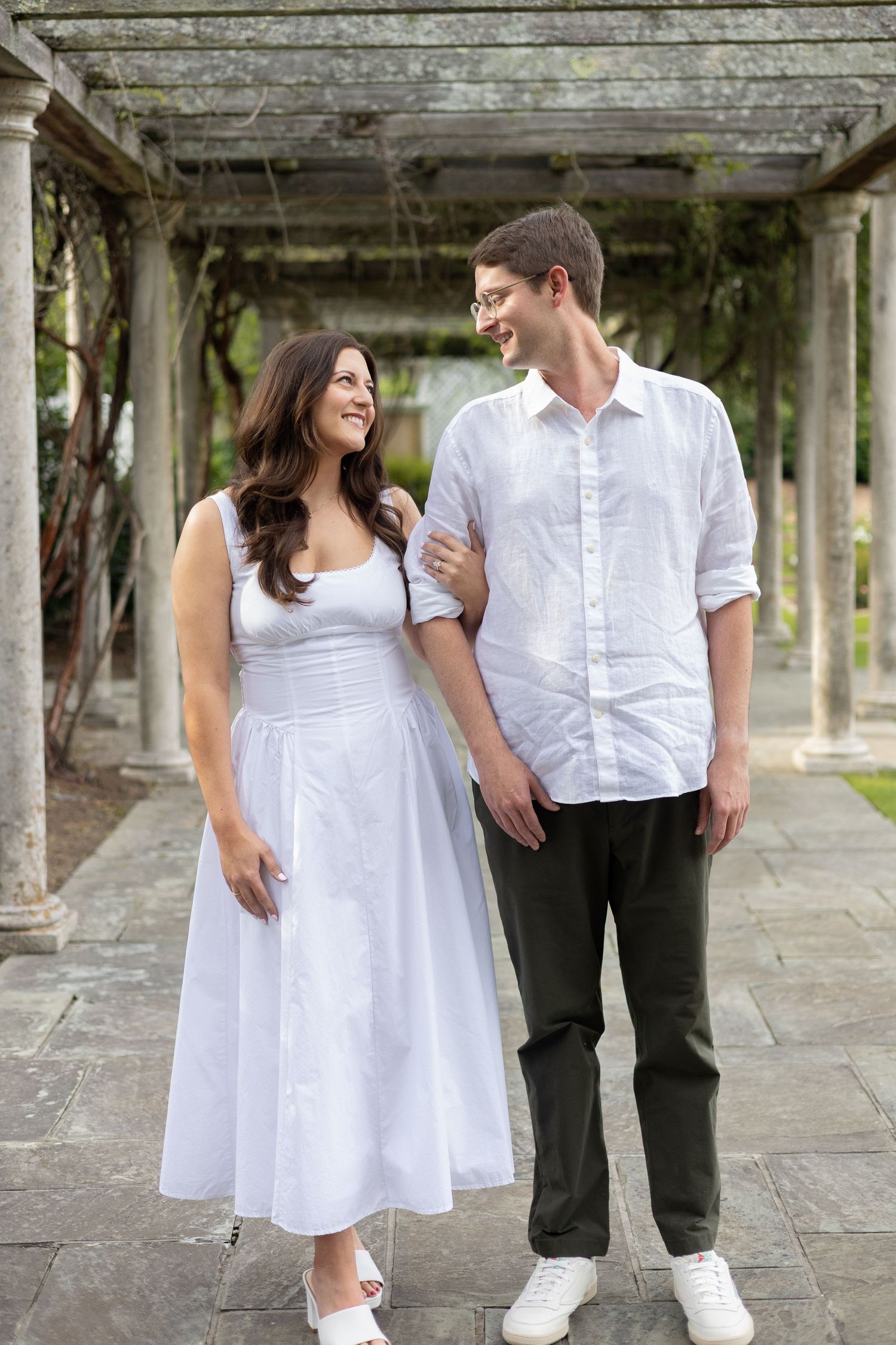 Couple standing together under a garden pergola, Huntsville Alabama engagement session