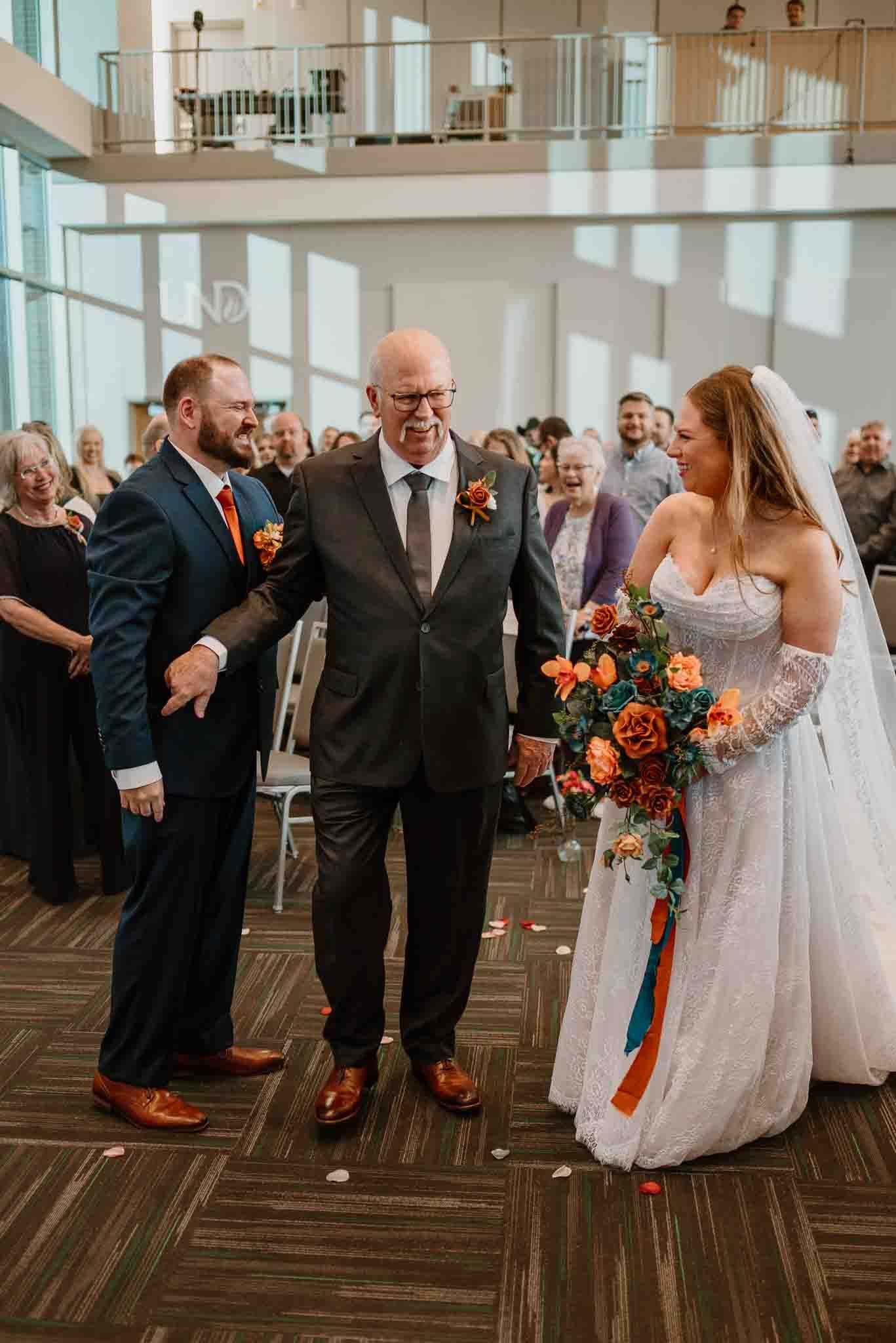 Bride walking down the aisle with her father during the wedding ceremony