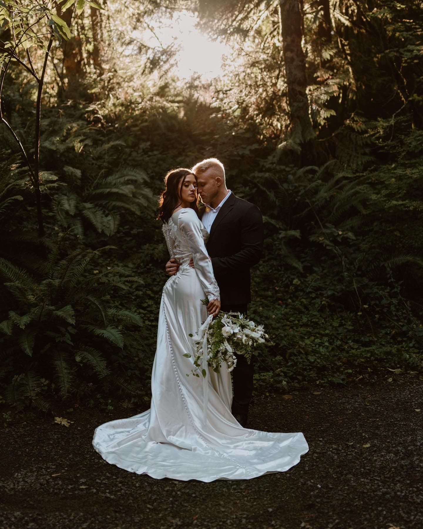 Couple having an intimate moment after their ceremony in the woods in Oregon
