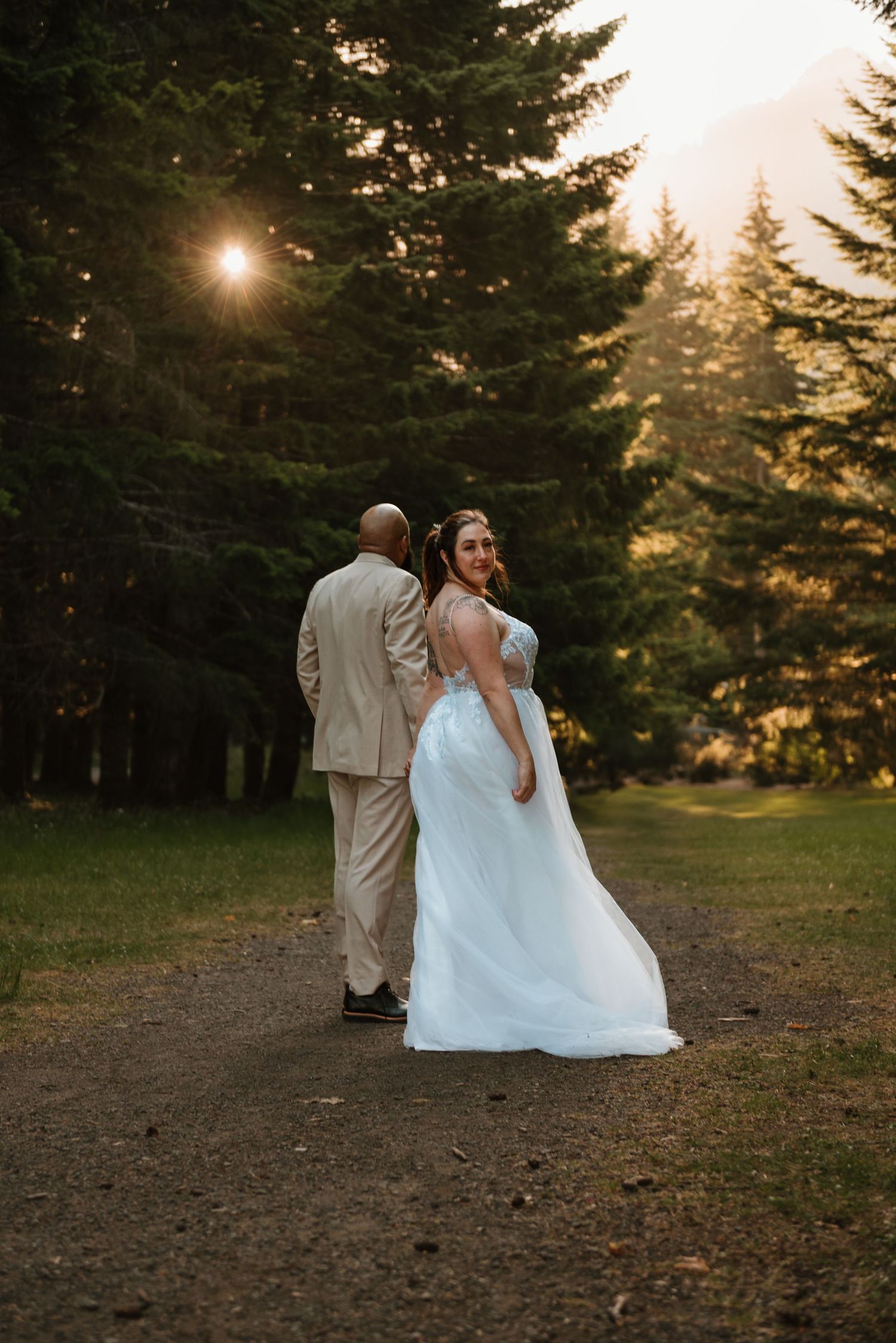 Couple walking away from their vows on the beach of Lake Crescent in the woods in Olympic National Park