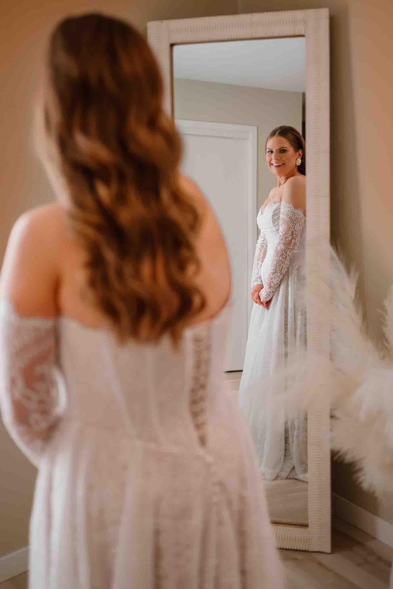 Bride seeing herself in her wedding dress before the ceremony at an Airbnb in Grand Forks