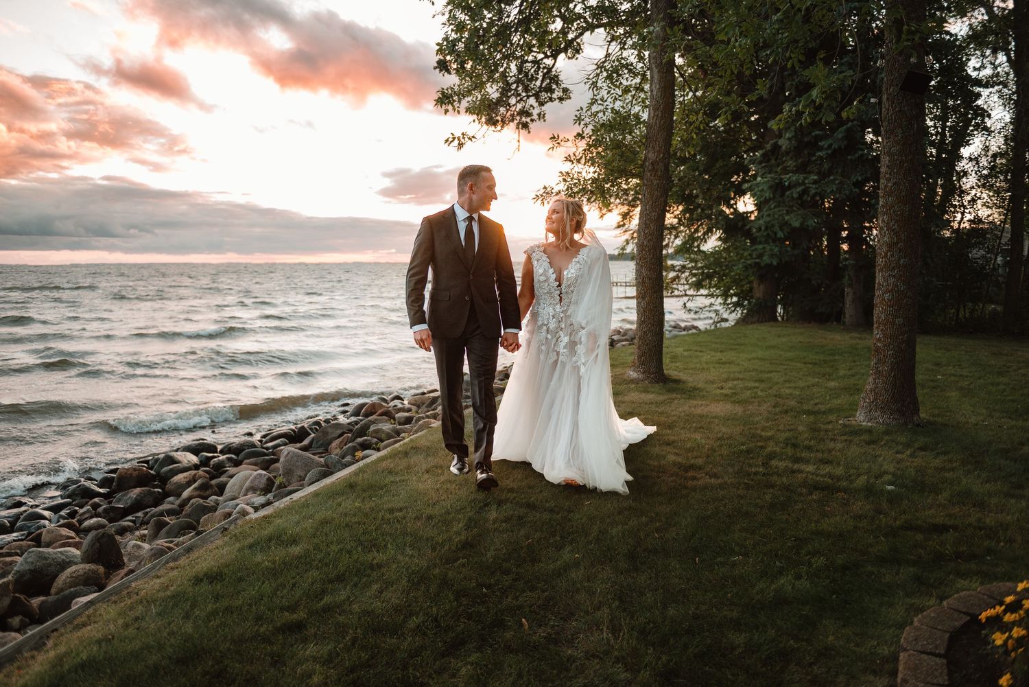 Couple walking along Mille Lacs Lake in Minnesota during a stormy sunset