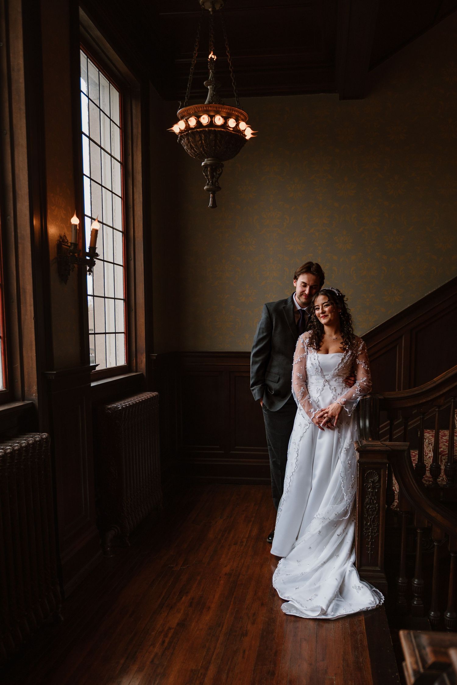 Couple standing together on the historic stair landing at Semple Mansion in Minneapolis Minnesota