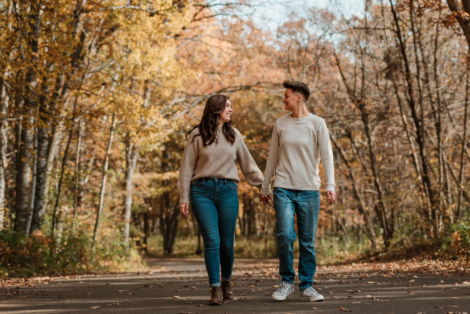 Couple walking together in soft morning light during their engagement photos in Minnesota