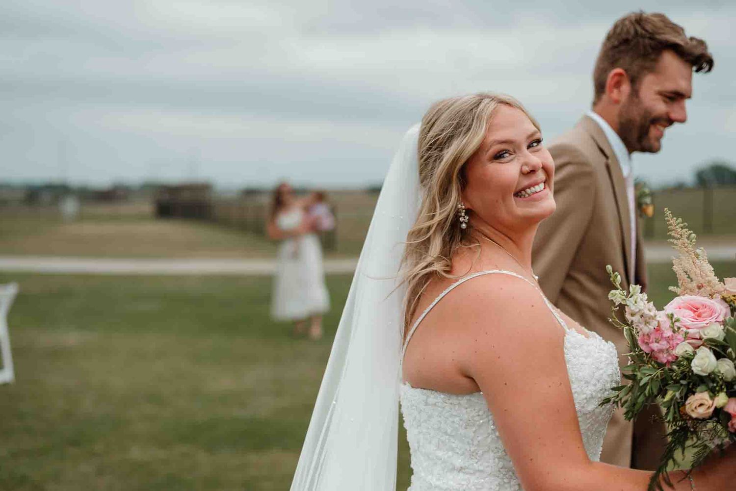 Bride and groom celebrating while walking back down the aisle at The Crescent