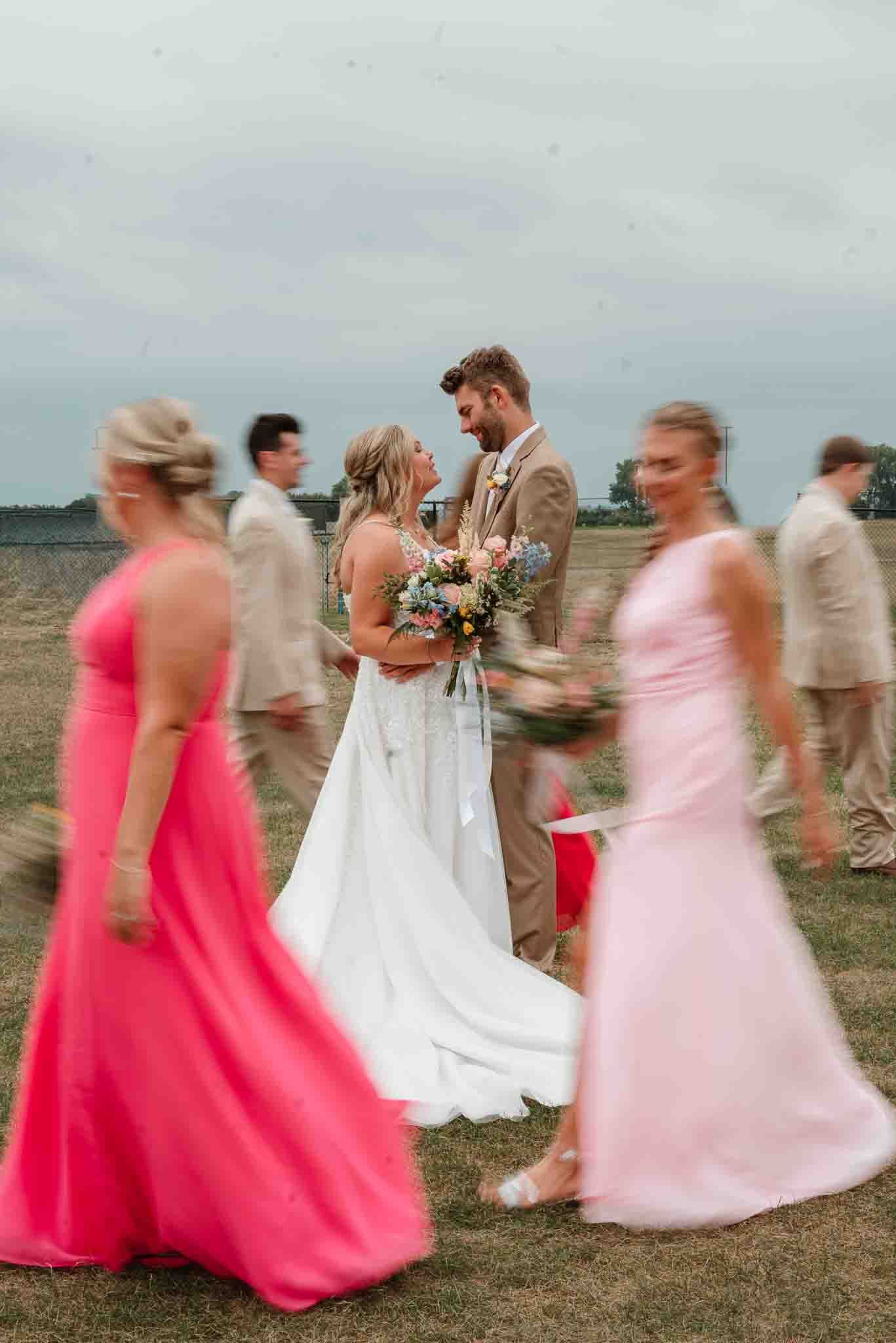 Wedding party laughing together during playful group photos in Wisconsin