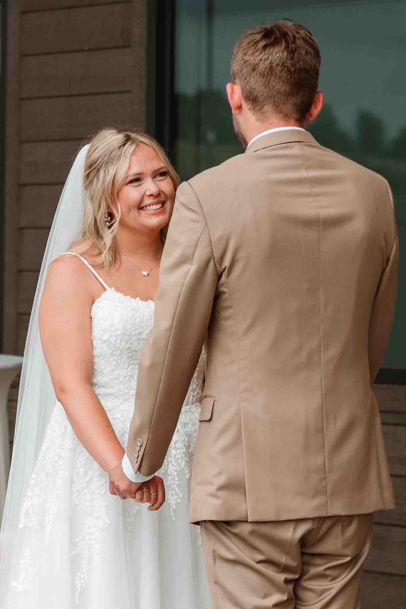 Newlyweds holding hands during their wedding ceremony in Wisconsin