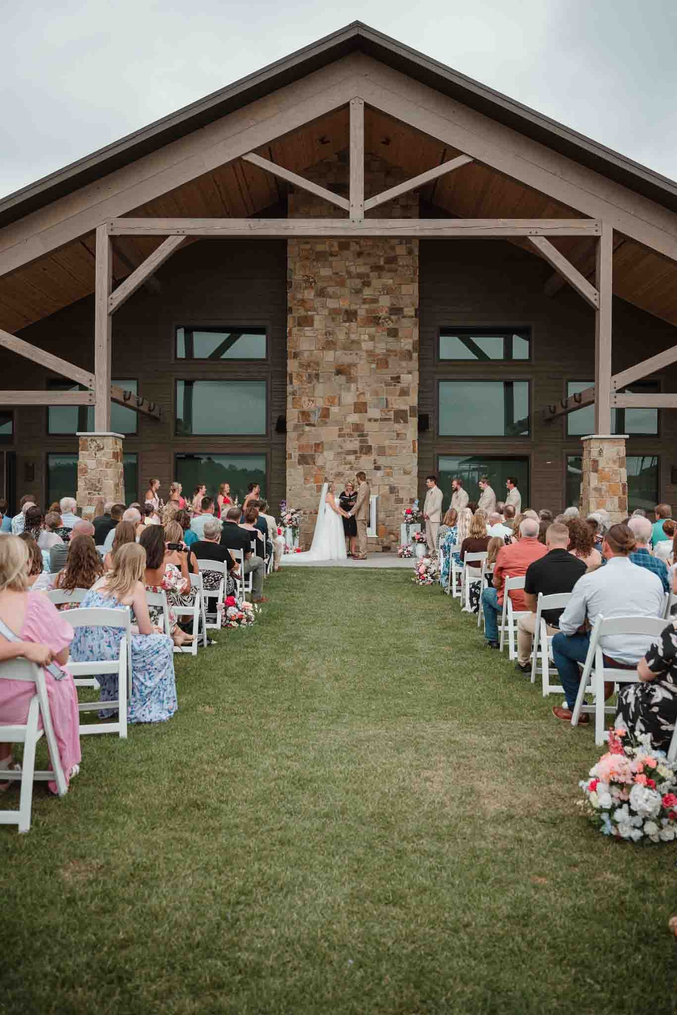 Newlyweds exchanging vows during an outdoor Wisconsin wedding ceremony at The Crescent