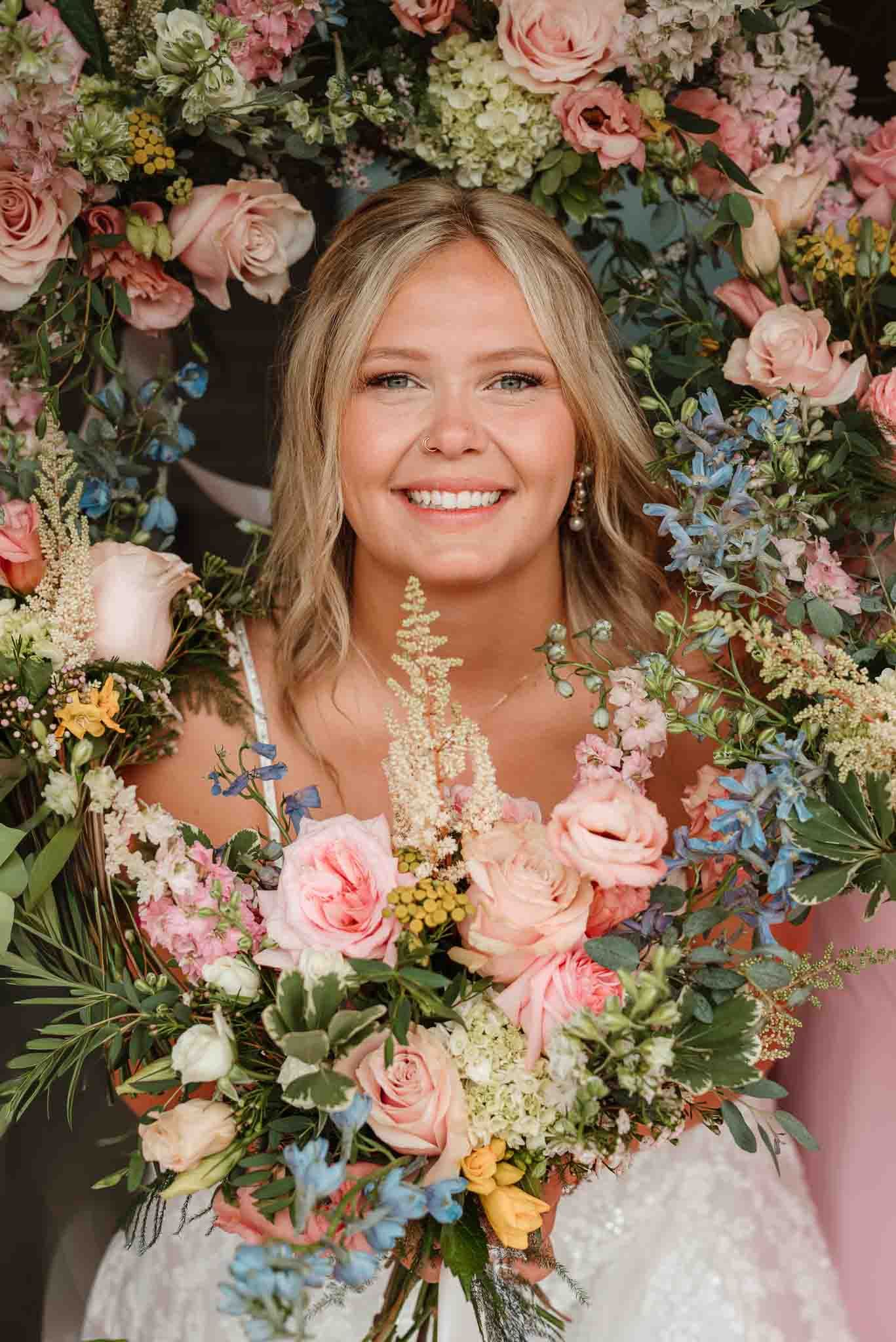 Bride with bouquets surrounding her face in Wisconsin