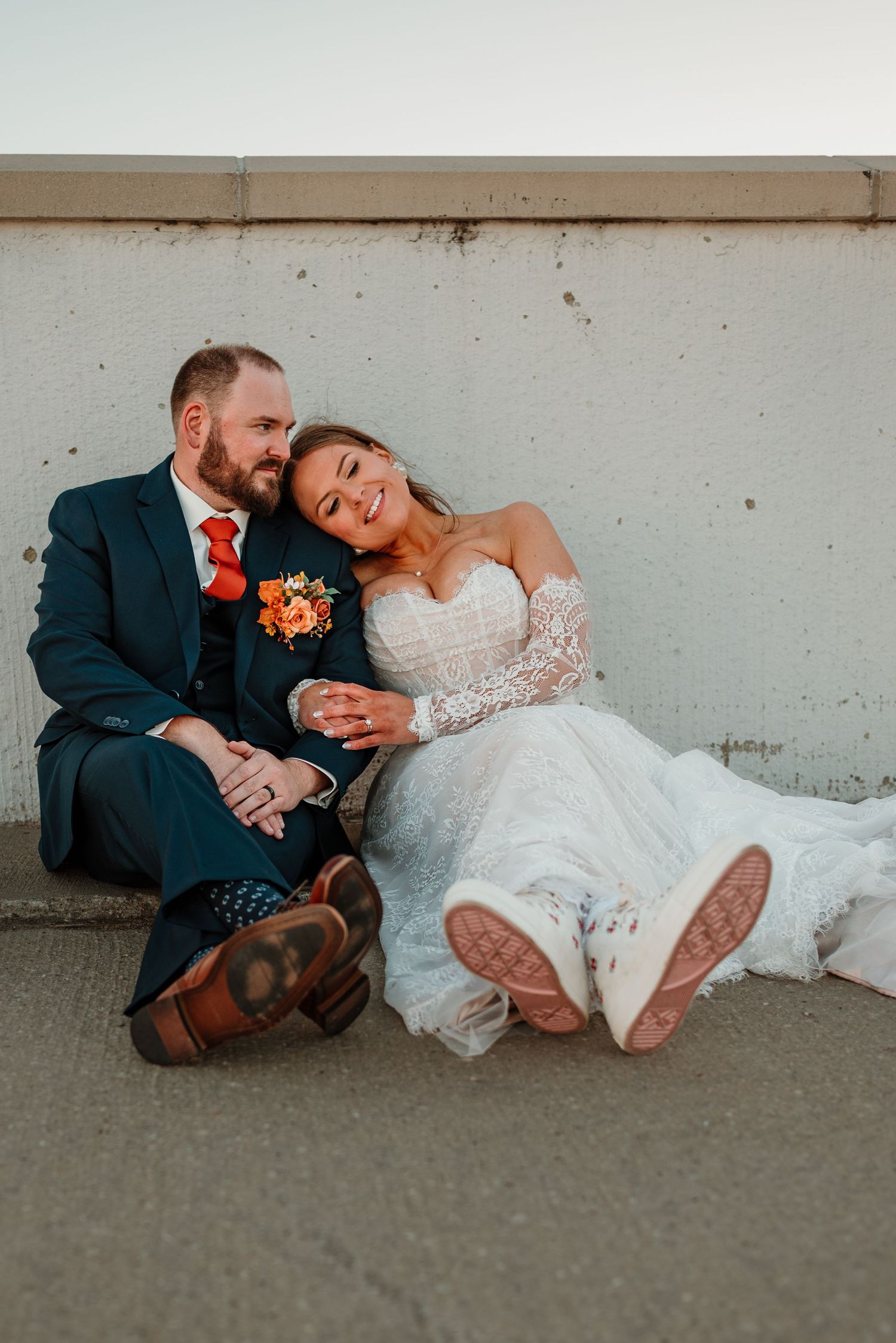 Couple cuddling sitting on the top of the parking garage in Grand Forks North Dakota