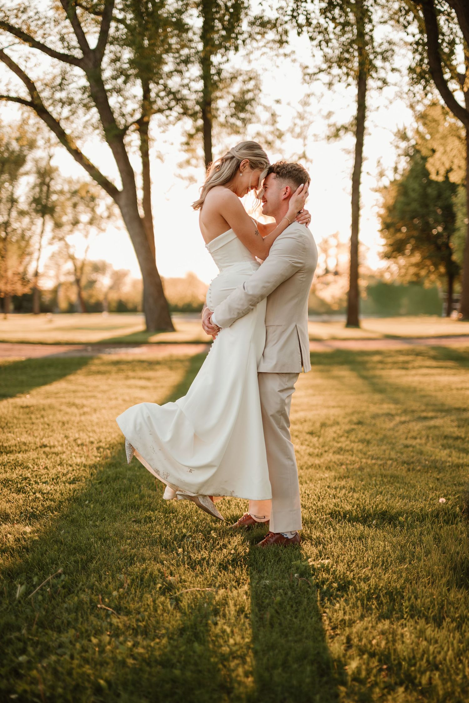 Newlyweds surrounded by warm sunset light during outdoor portraits in Minnesota