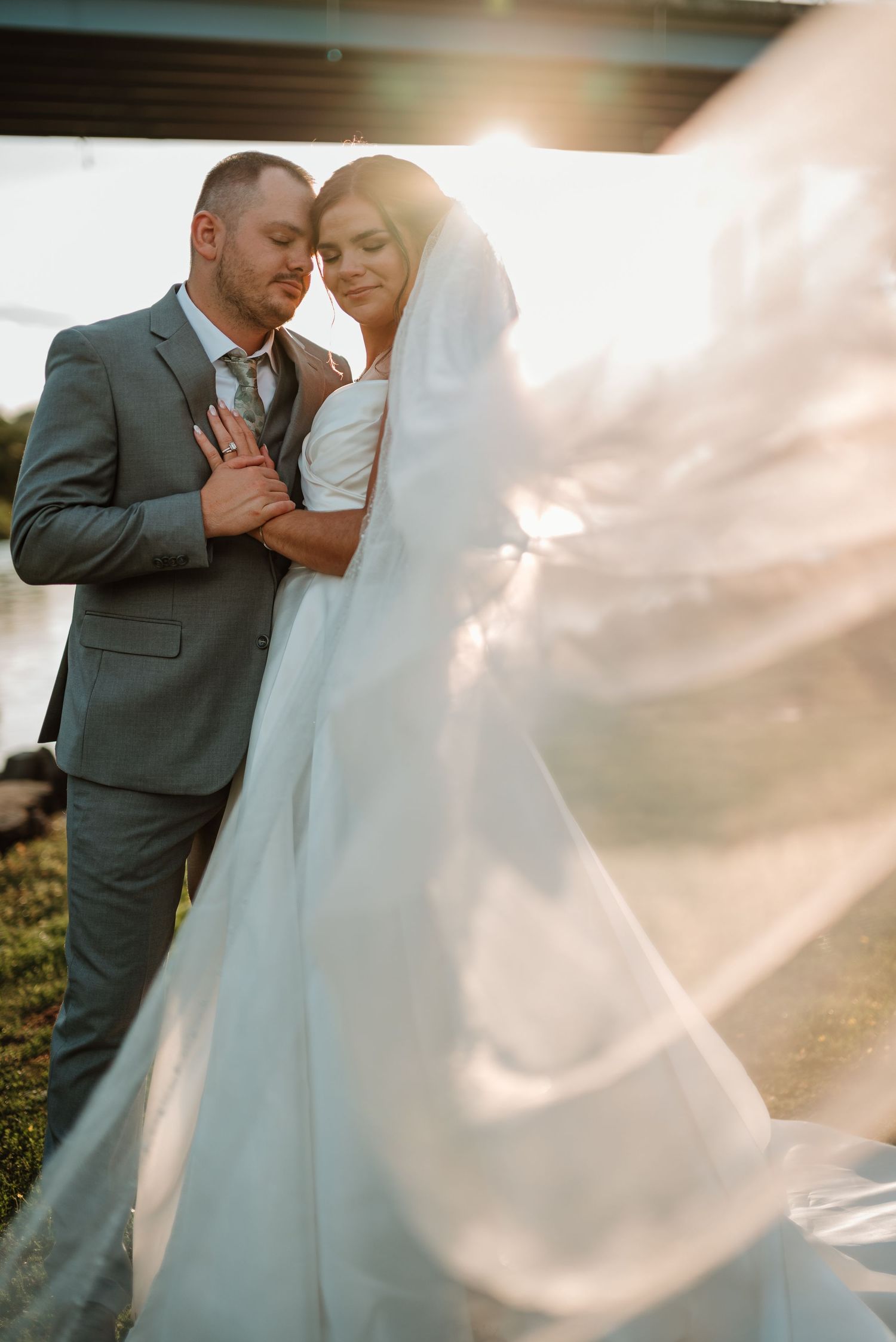 Couple touching foreheads during a quiet wedding portrait at West Edison Rivery in Appleton