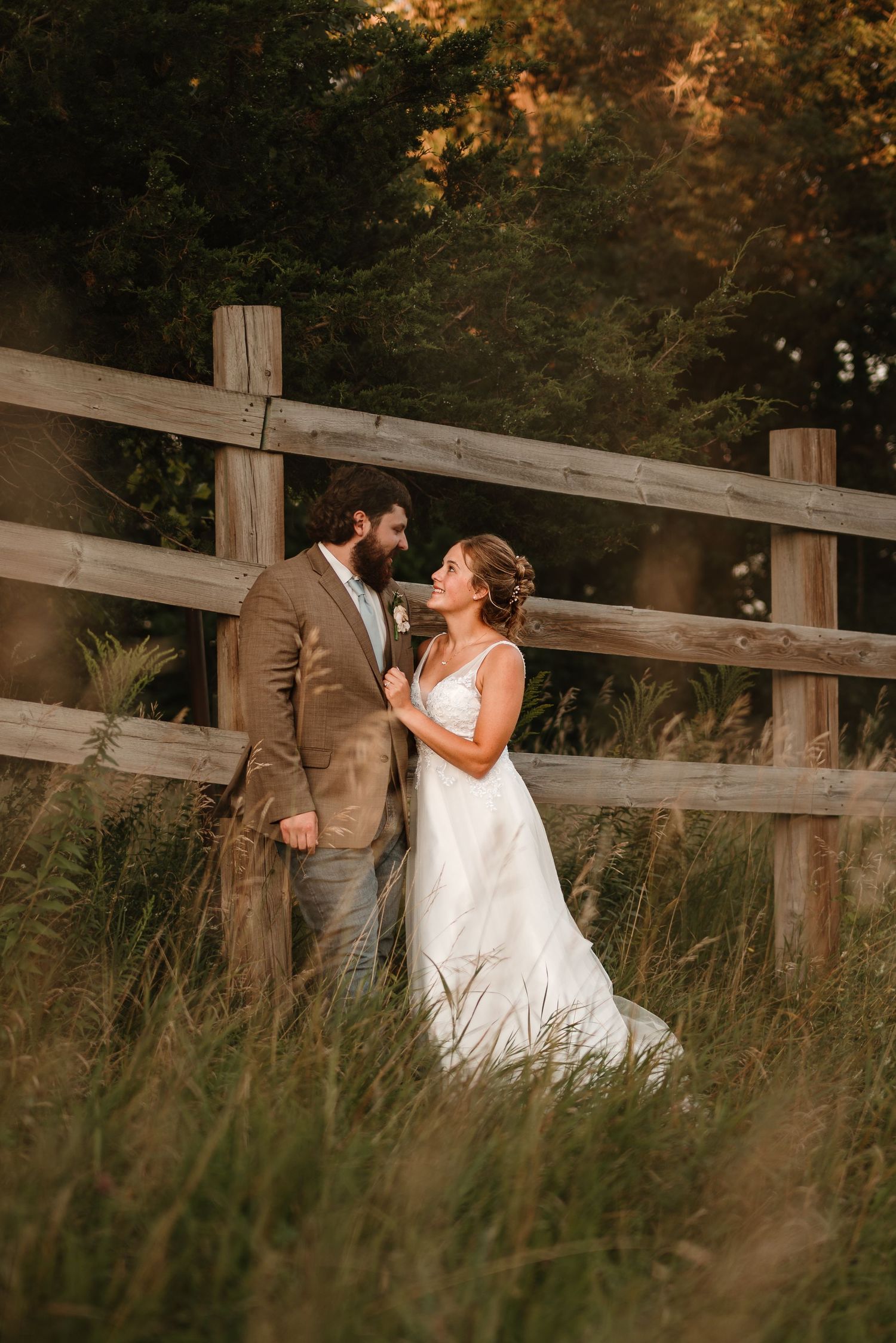 Couple outside in a field during golden hour during their reception in Minnesota