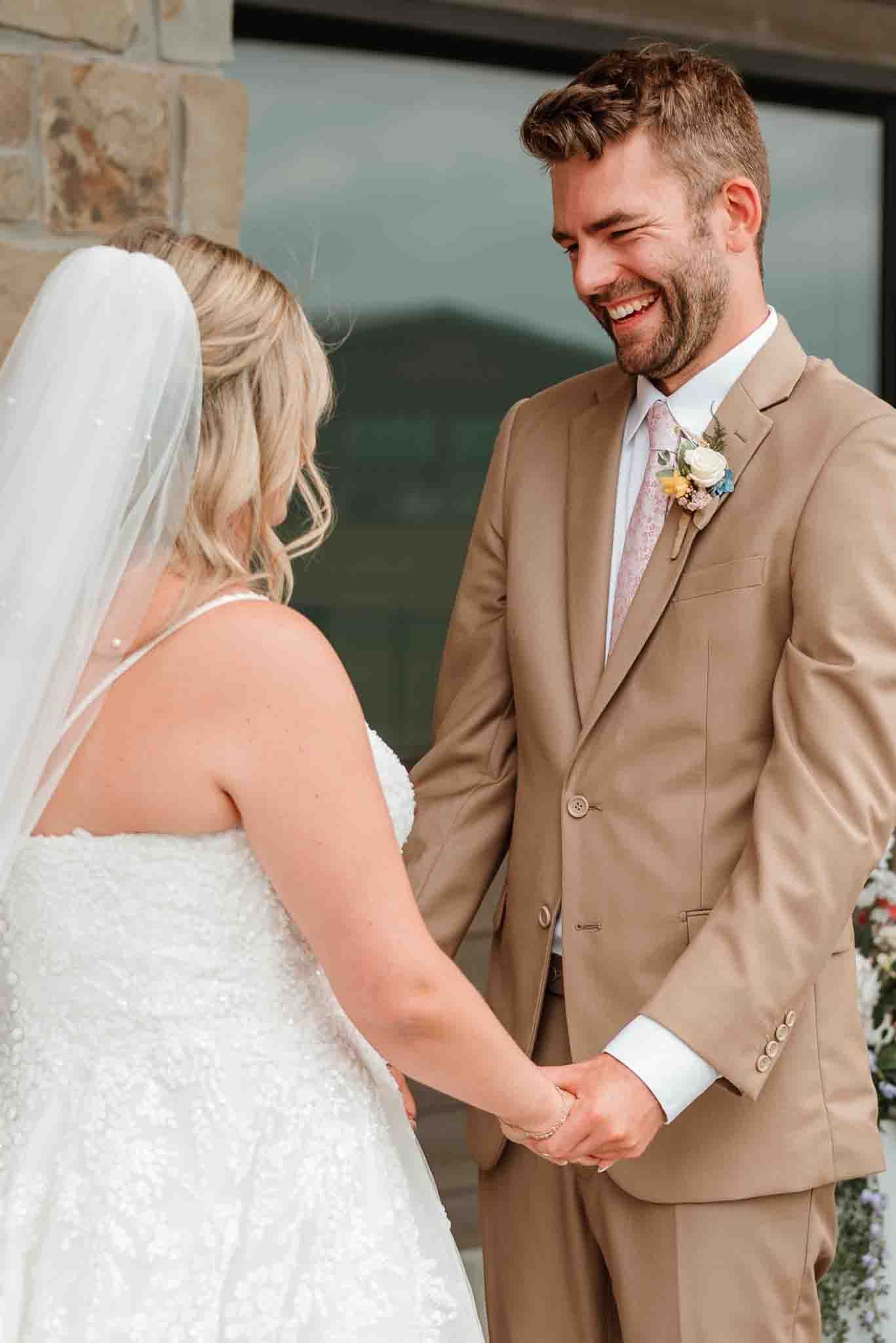 Newlyweds holding hands during their wedding ceremony in Wisconsin